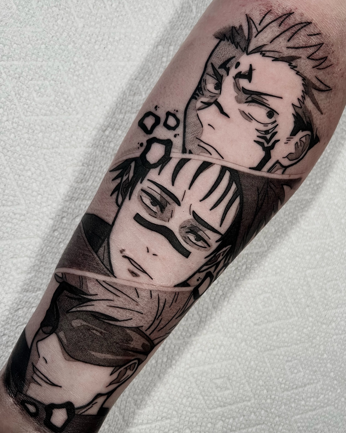 Anime characters anime tattoo on the forearm by Chandler Roe