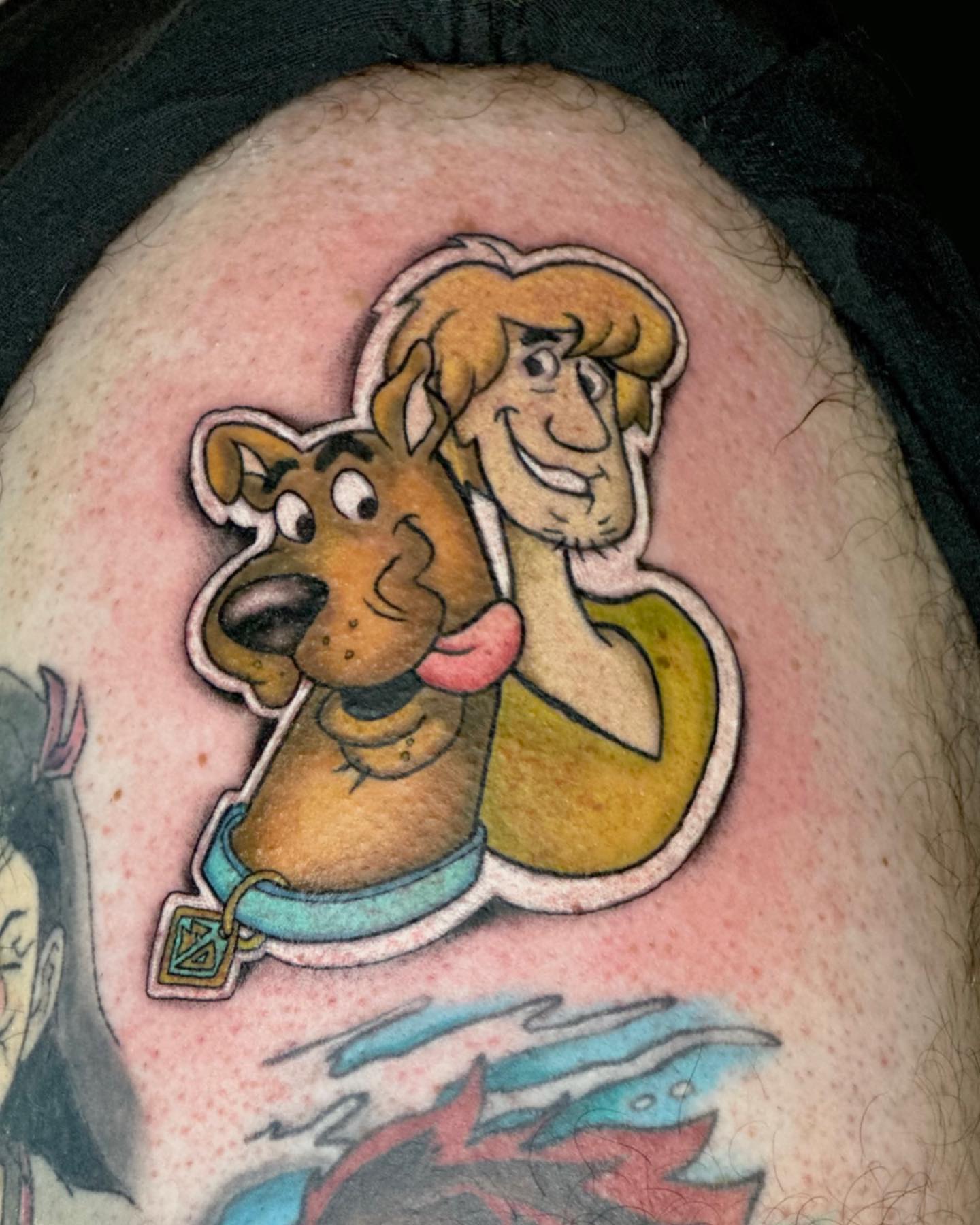Scooby-Doo and Shaggy illustrative tattoo on the torso by Erika Nambo