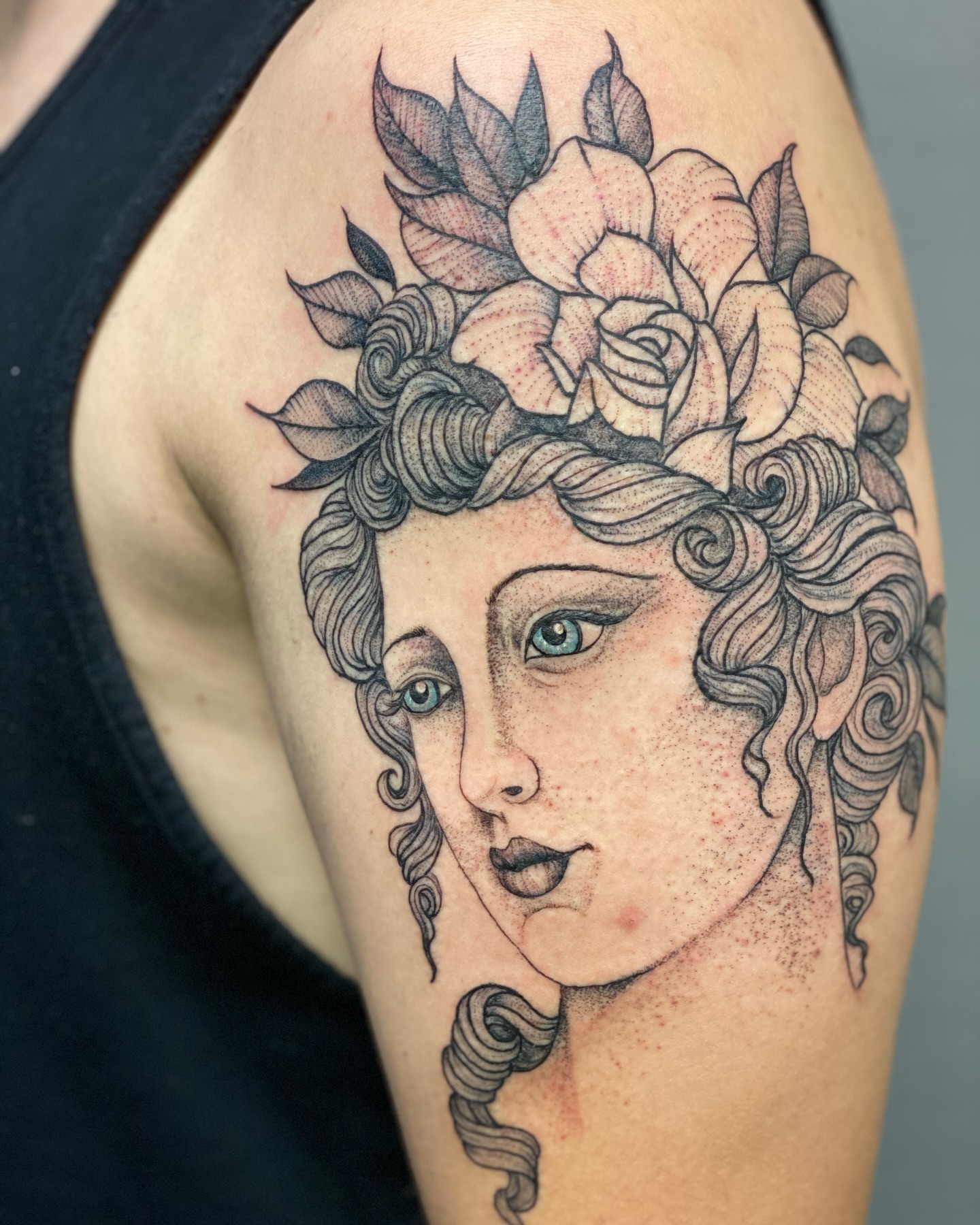 Woman's head with roses dotwork tattoo on the shoulder by Benjamin Carlson