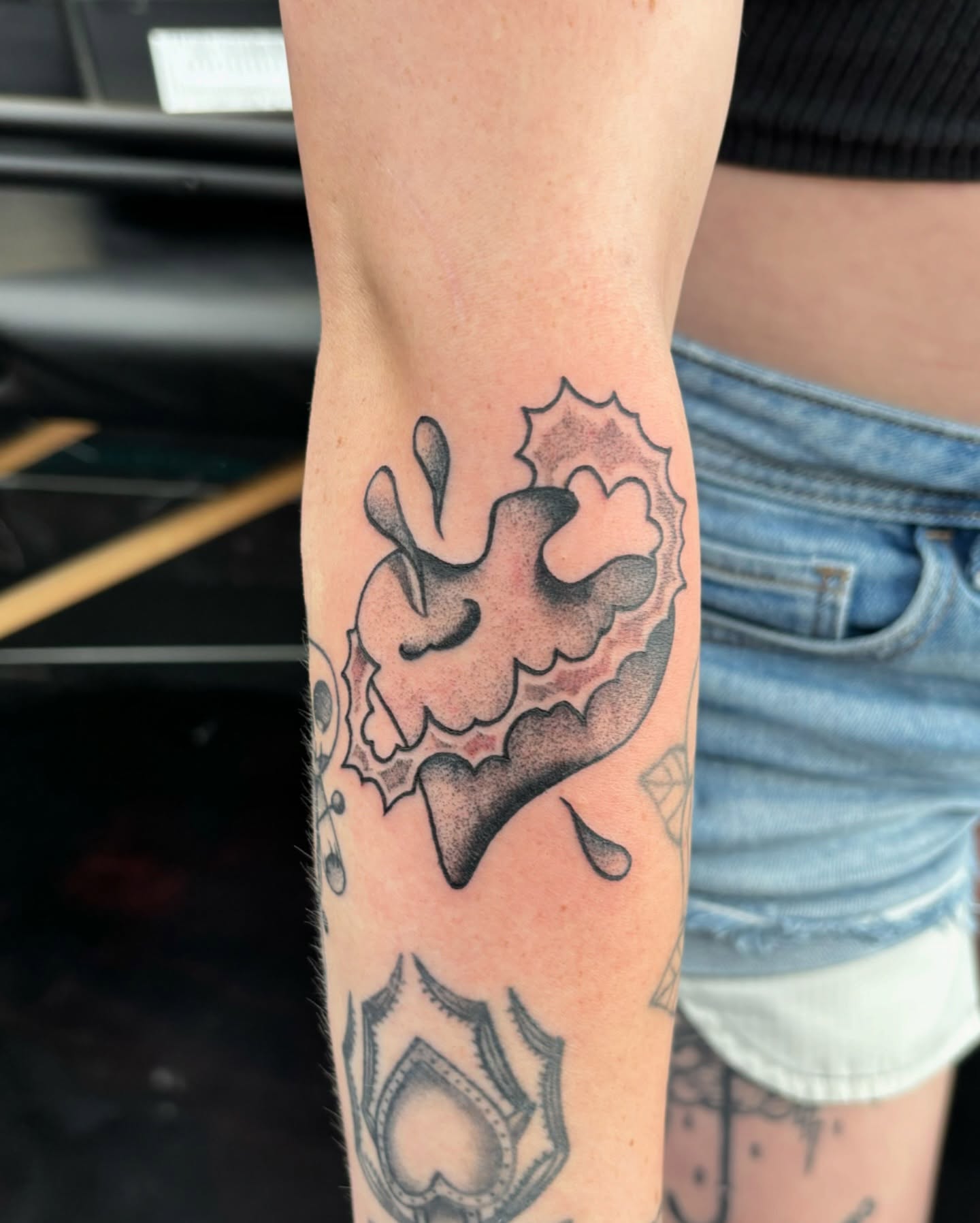 Abstract splatter dotwork tattoo on the forearm by Jordan Wray