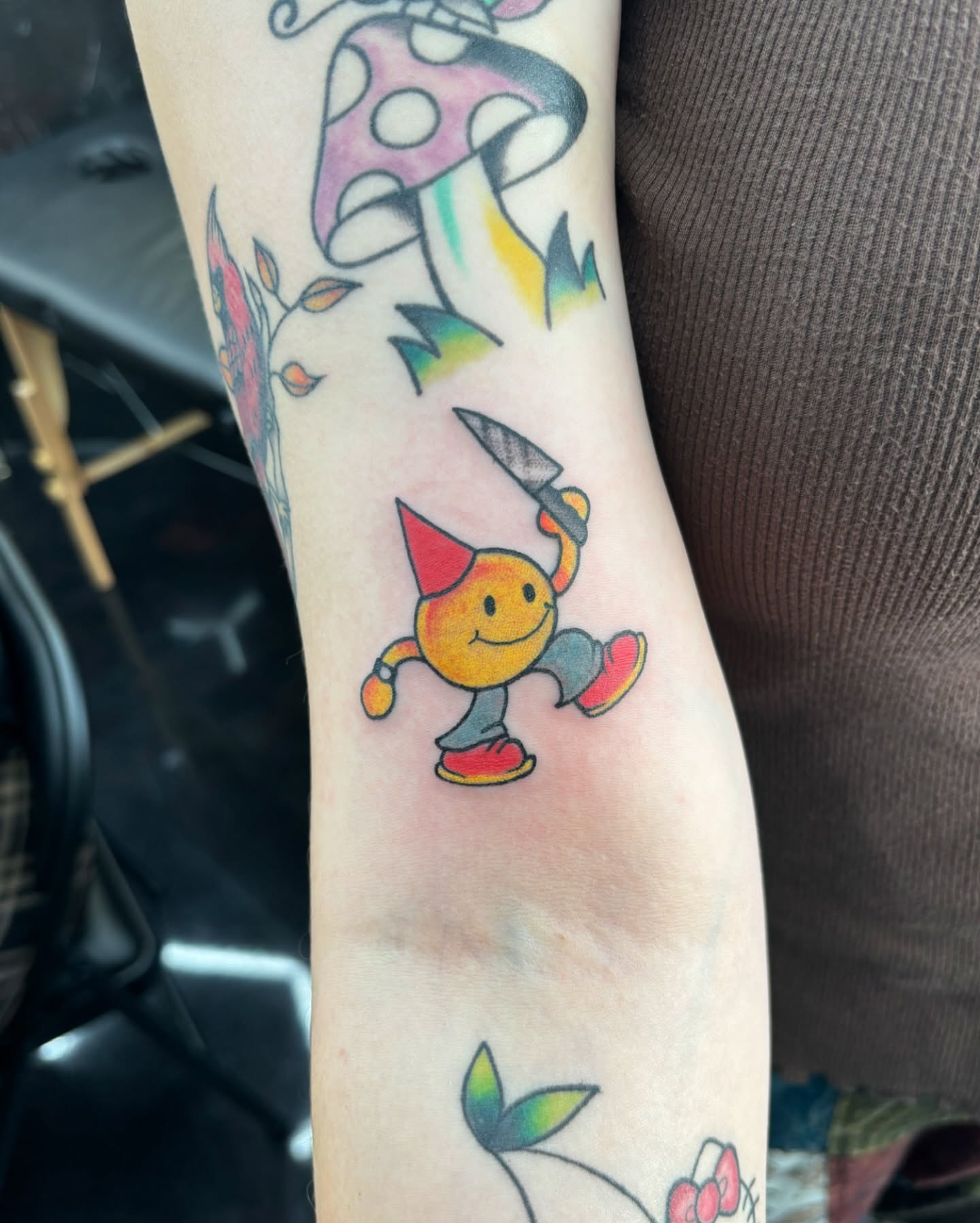 Smiley character new school tattoo on the forearm by Jordan Wray