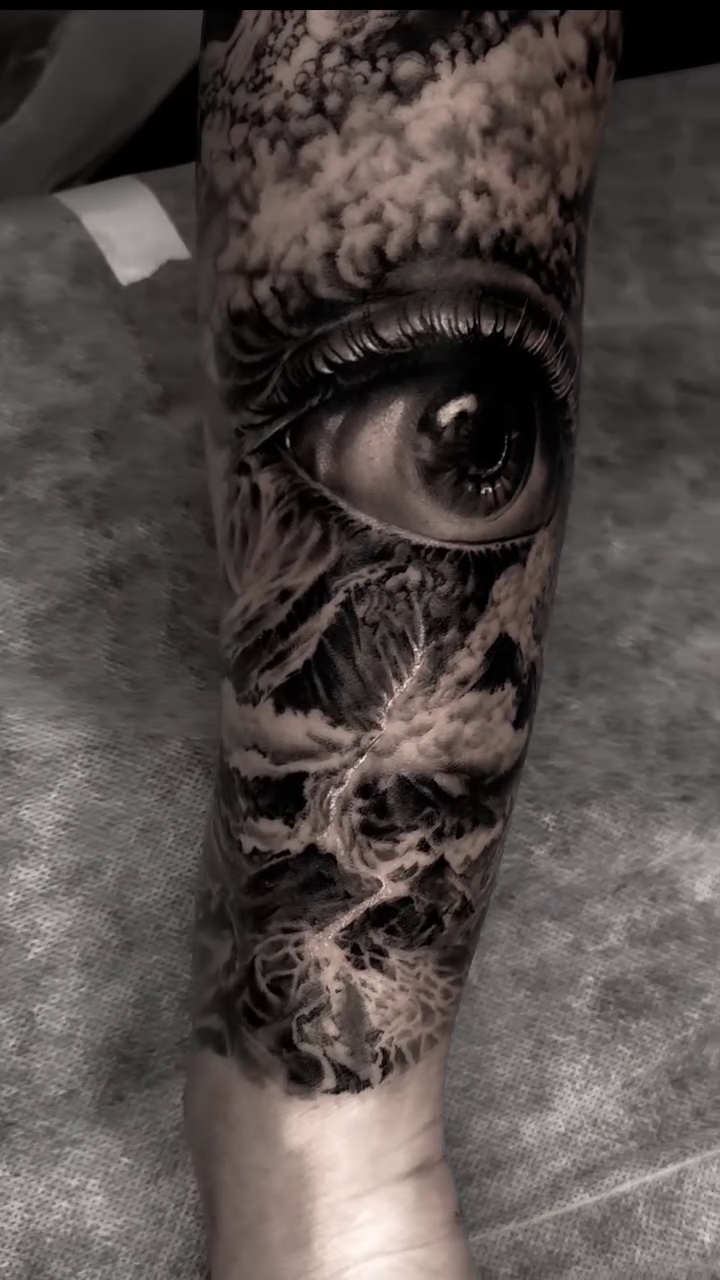 Eye and clouds realism tattoo by Pitasso tattoo black and grey