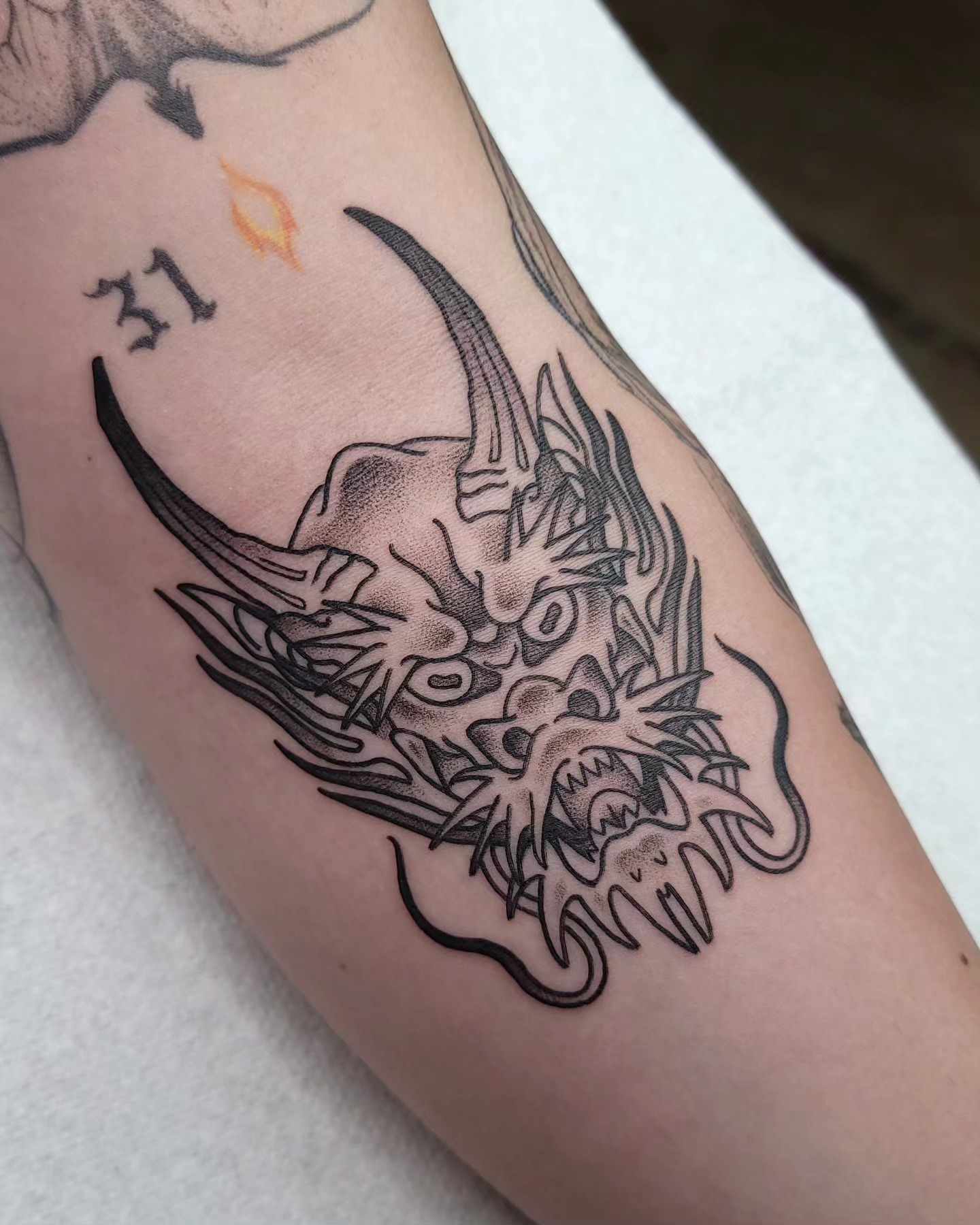 Bull skull black and grey tattoo on the forearm by Ghost