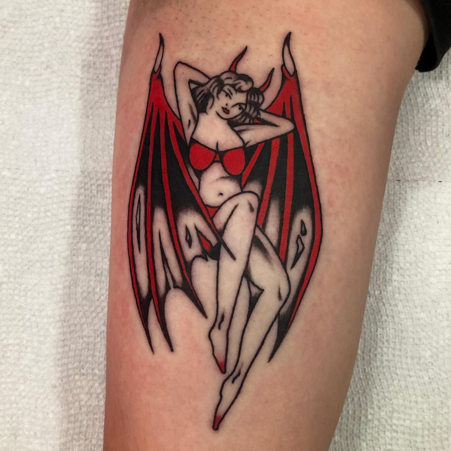 Winged woman American traditional tattoo on the thigh by brenden