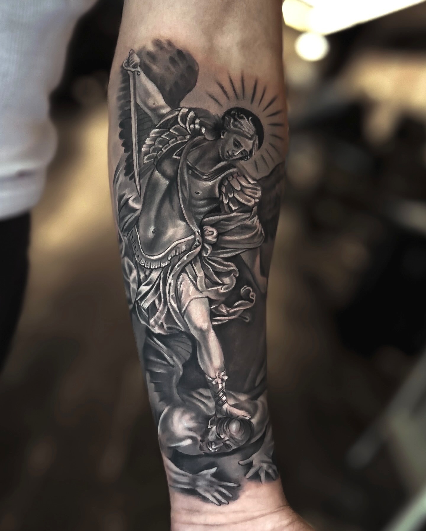 Angel and demon realism tattoo on the forearm by Luis Manuel Olivera, North Miami, Florida