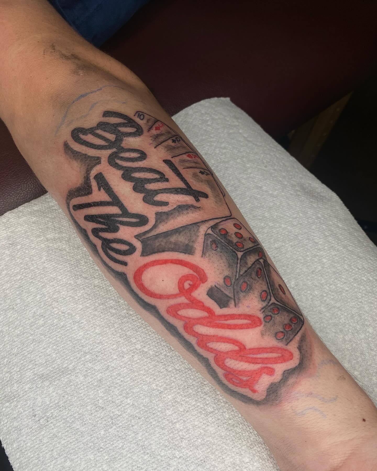 Beat the odds black and grey tattoo on the forearm by Evan Chastain