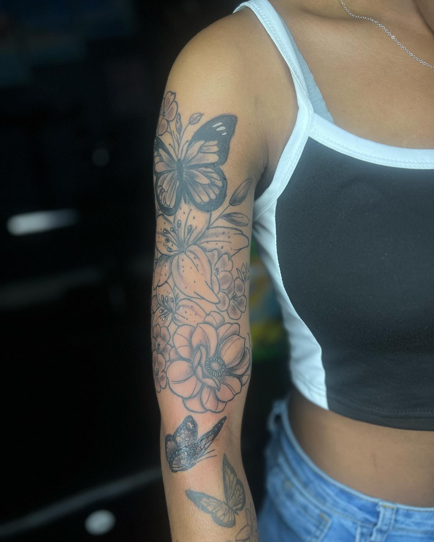 Butterfly and flowers dotwork tattoo on the forearm by Glass Inkk