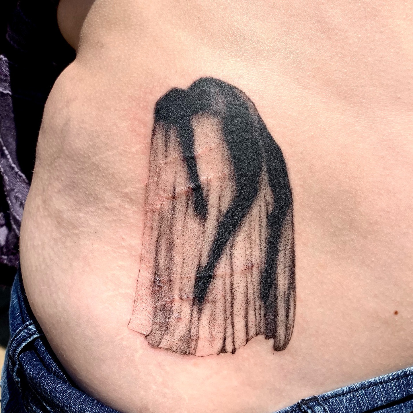 Abstract shape black and grey tattoo on the back by Maddy Paige