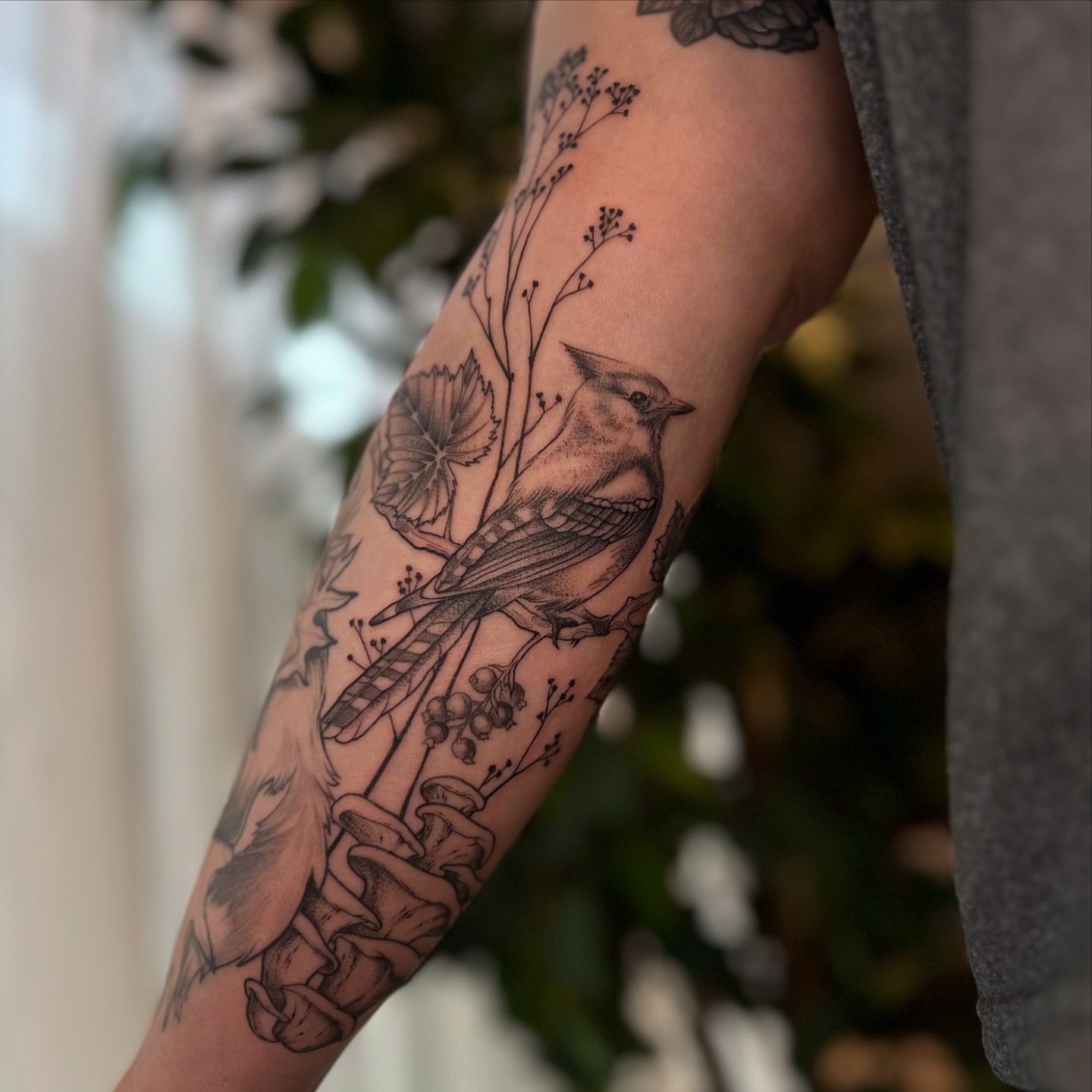 Bird and floral dotwork tattoo on the forearm by Dom