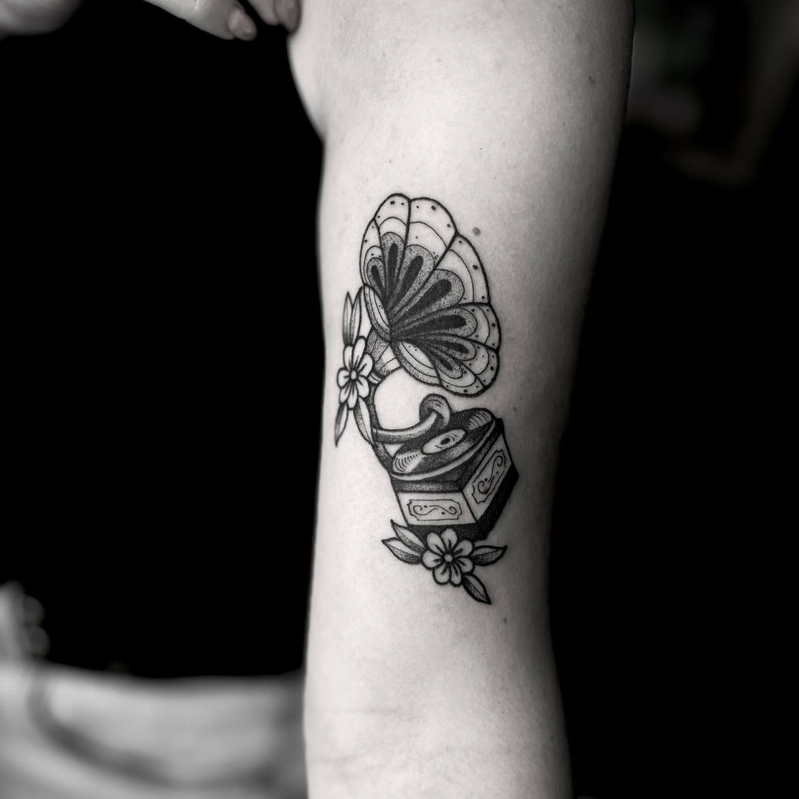 Gramophone and flowers black and grey tattoo on the forearm by t a y l o r