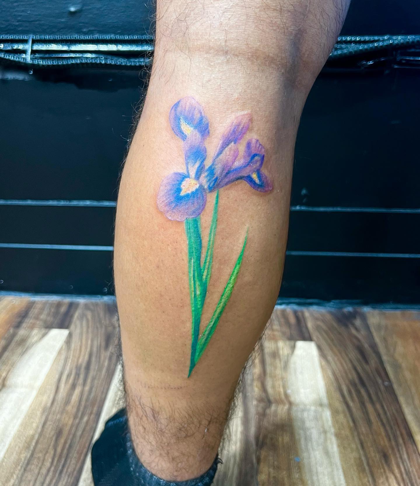 Iris flower realism tattoo on the calf by Eduardo Chaparro