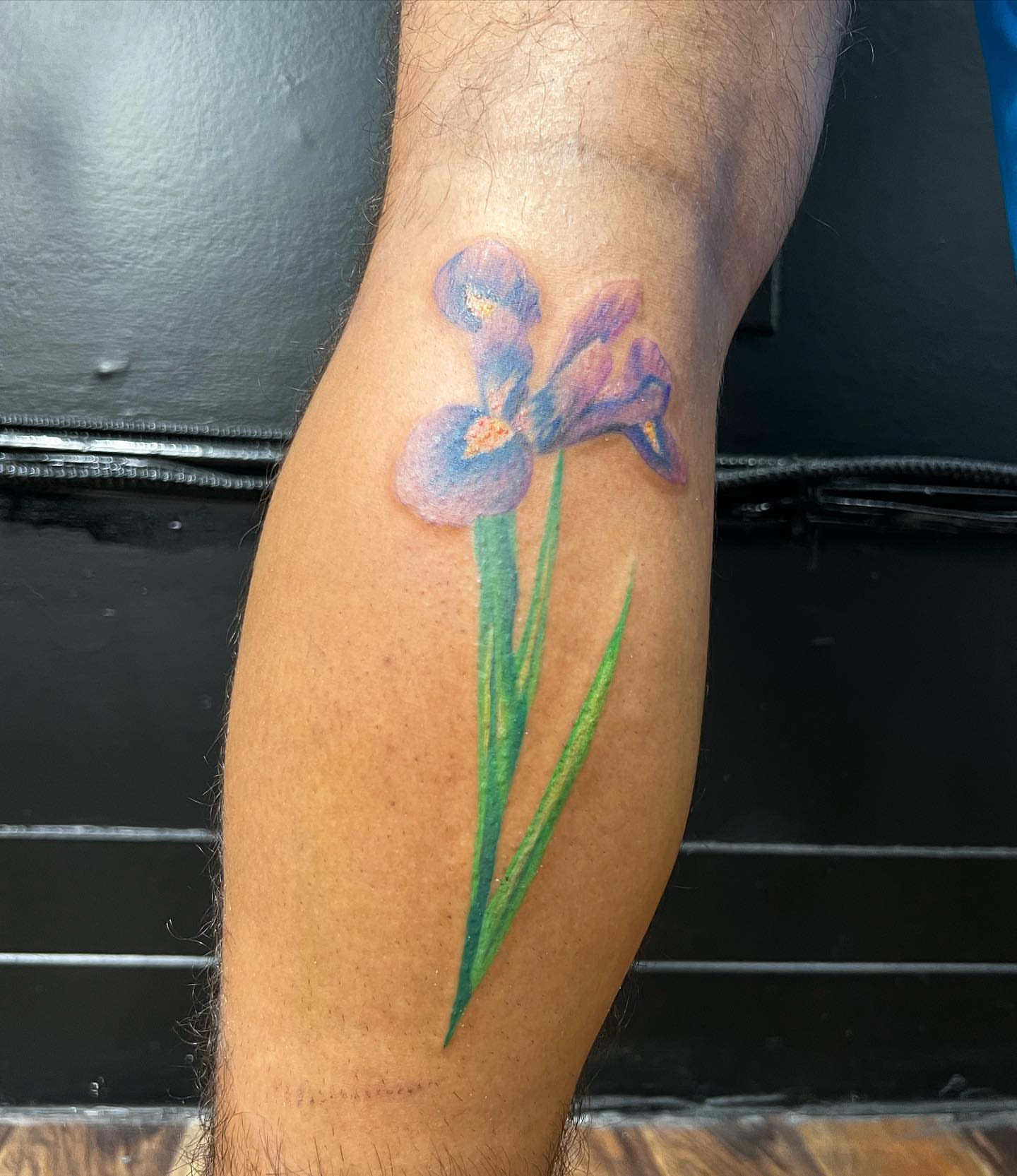Iris flower watercolor tattoo on the forearm by Eduardo Chaparro