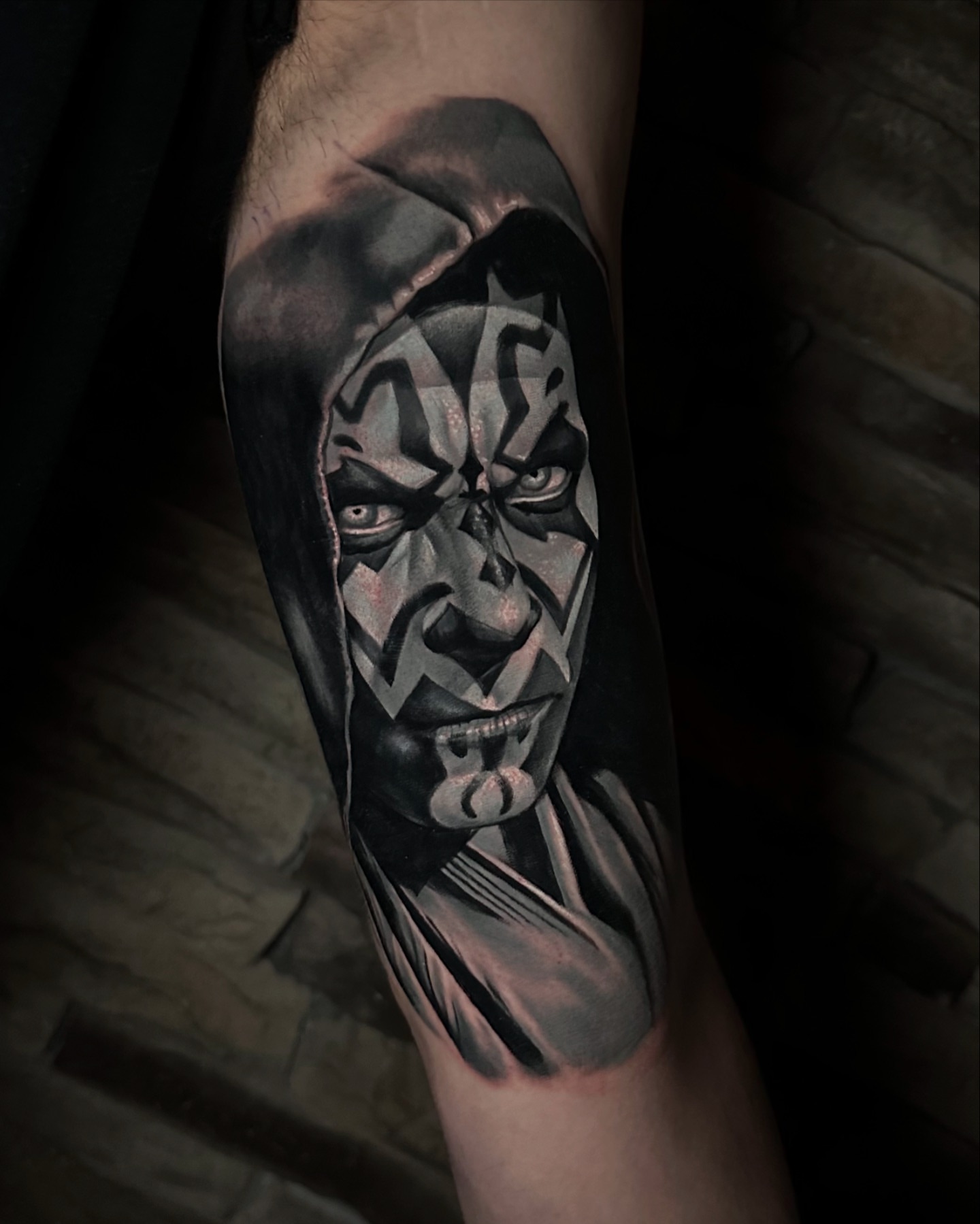 Demon face dark realism tattoo on the forearm by Dayron Gonzalez