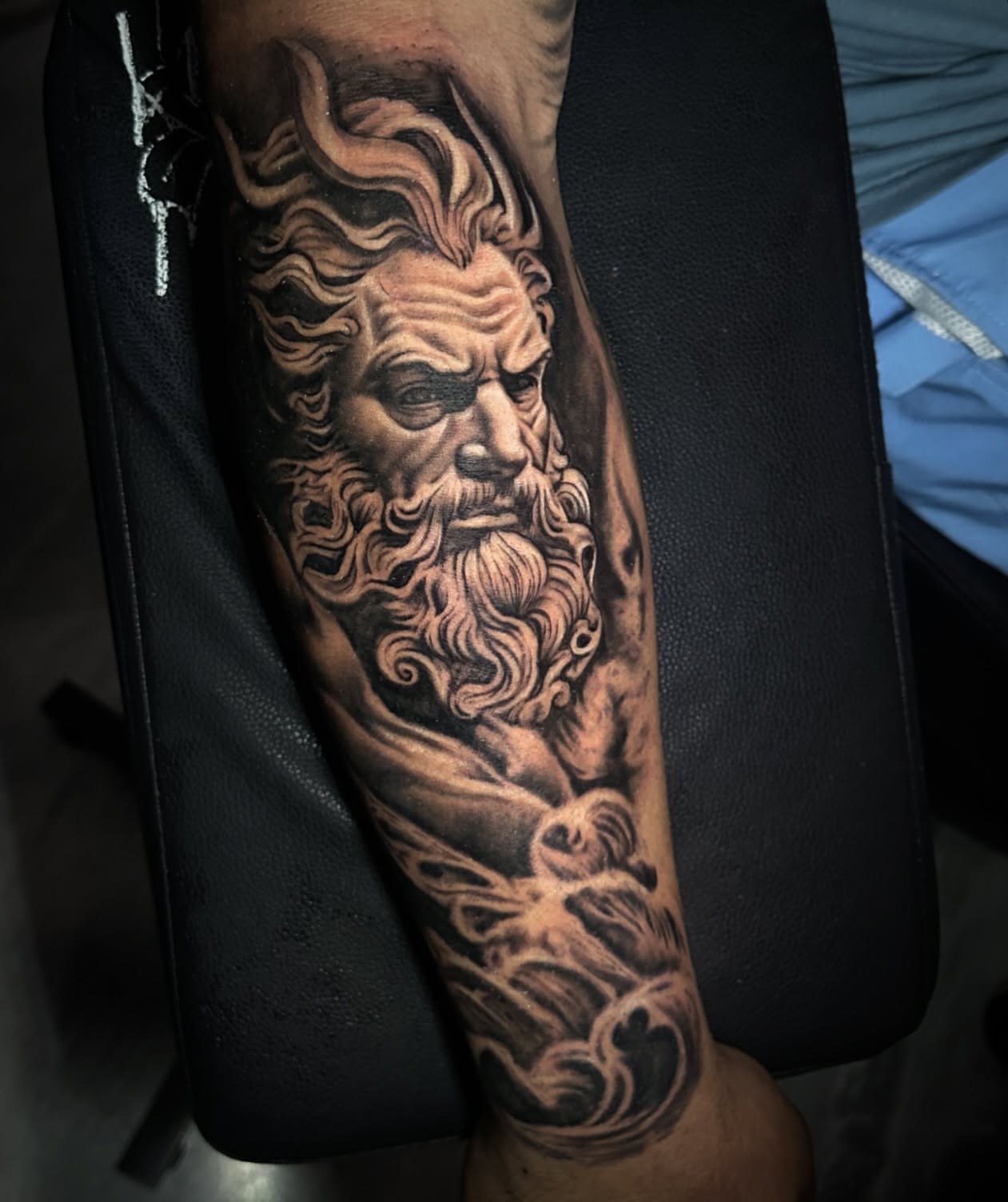 God-like figure realism tattoo on the forearm by Tattoo Artist - the Goat