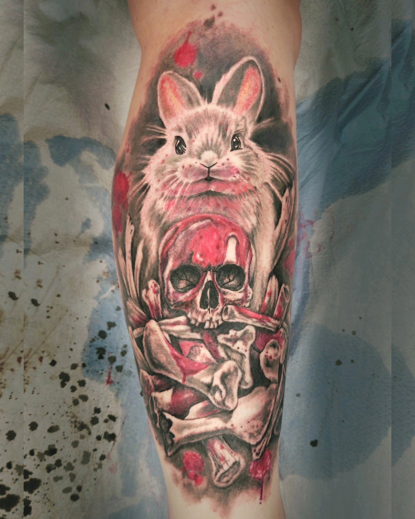Rabbit and skull realism tattoo on the forearm by Neil Ohmie