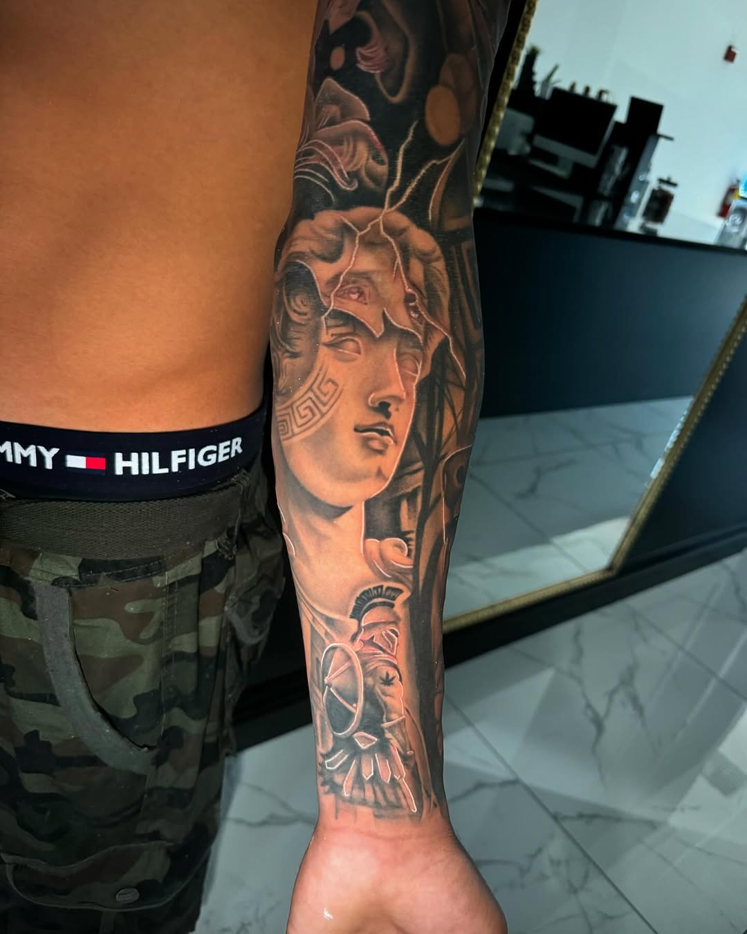 Greek bust and warrior realism tattoo on the forearm by Jose lopez jr