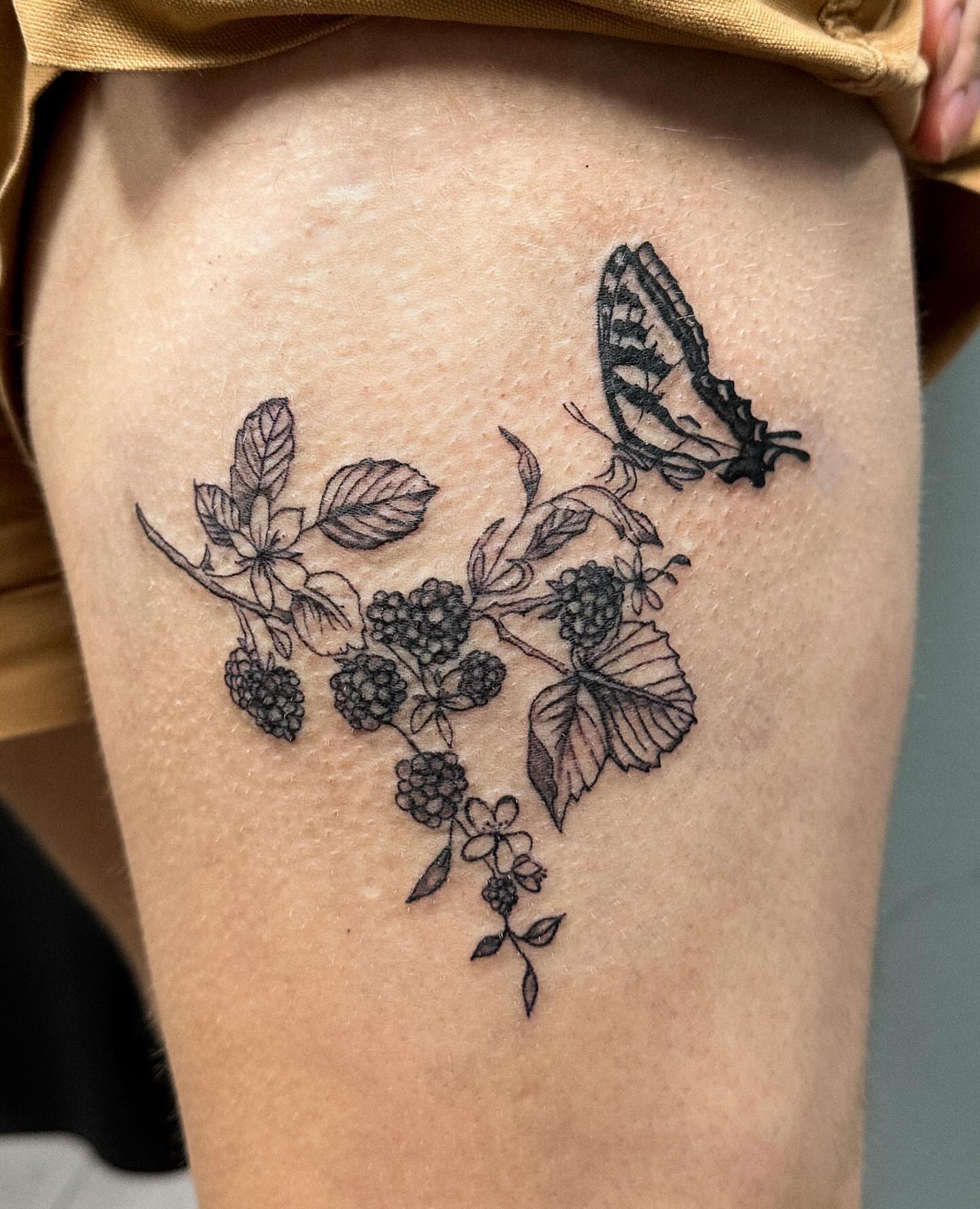 Berry branch with butterfly realism tattoo on the thigh by Portland Tattoo Artist
