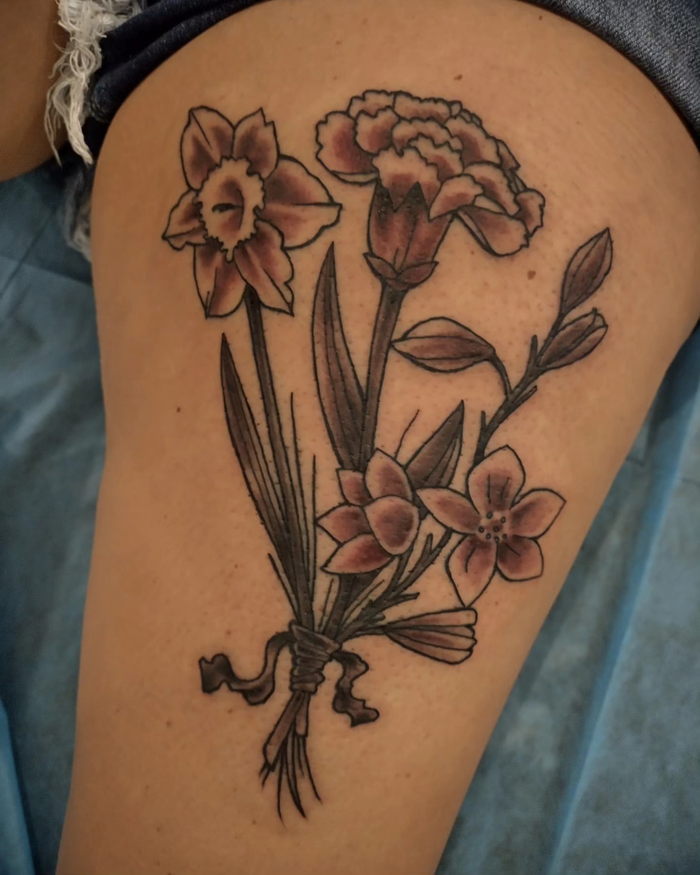 Flower bouquet black and grey tattoo on the thigh by Matt Williamson