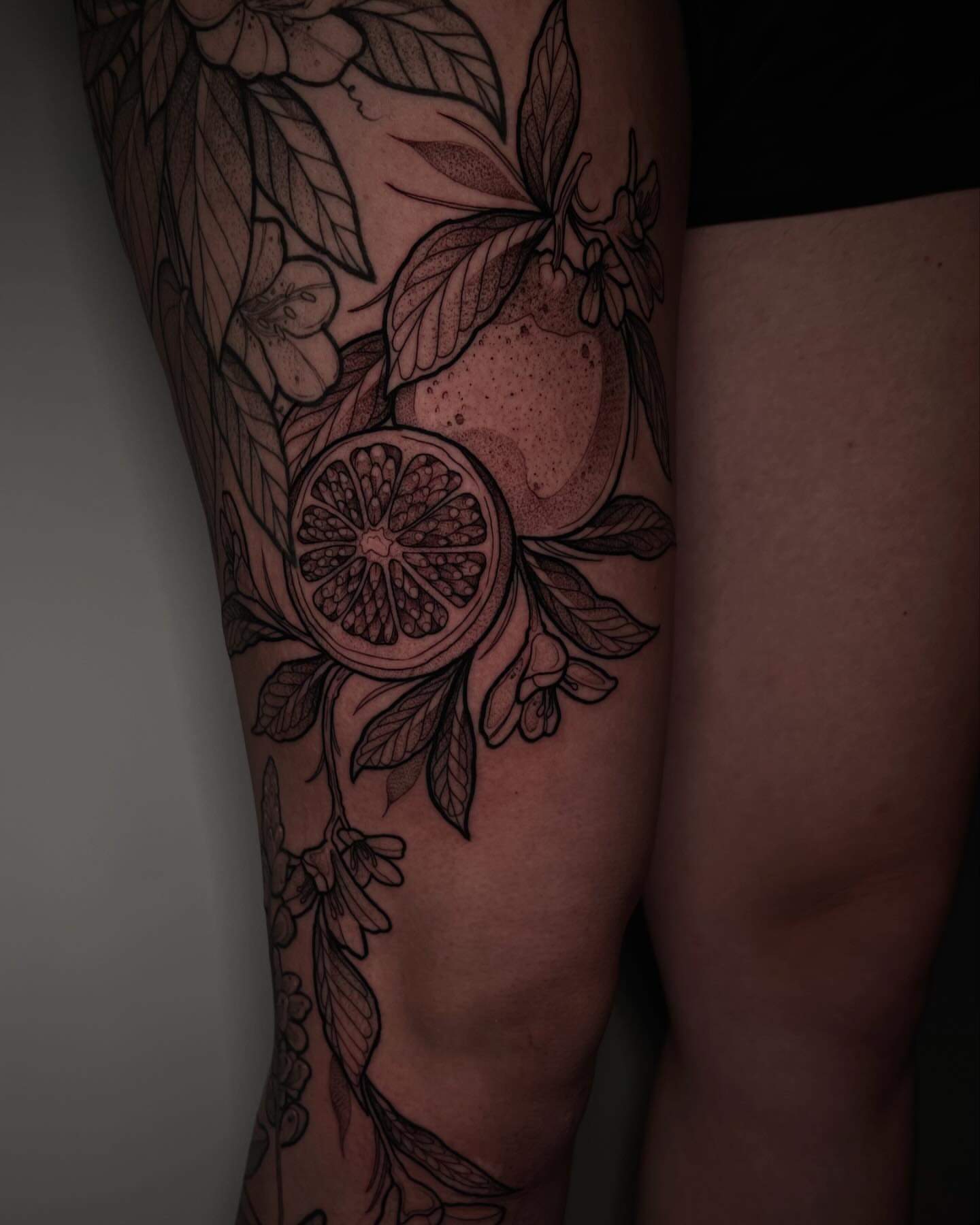 Citrus fruit and leaves realism tattoo on the thigh by H A N N A H, Colorado Springs, Colorado
