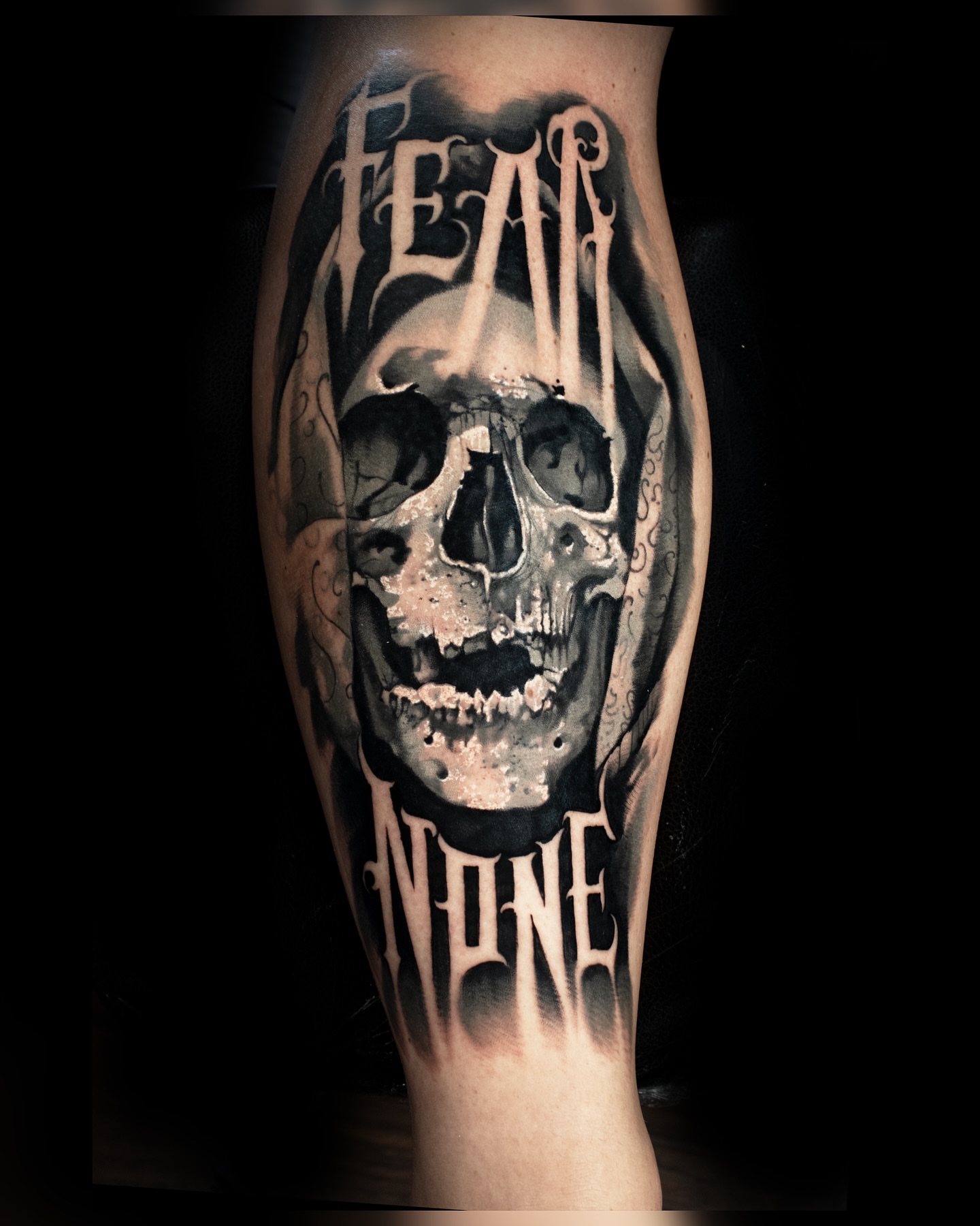 Skull realism tattoo on the calf by Luke Benavidez