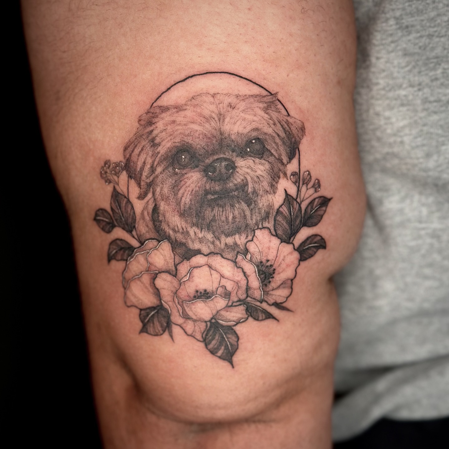 Dog with flowers realism tattoo on the thigh by Sabrina, Harrison, New Jersey