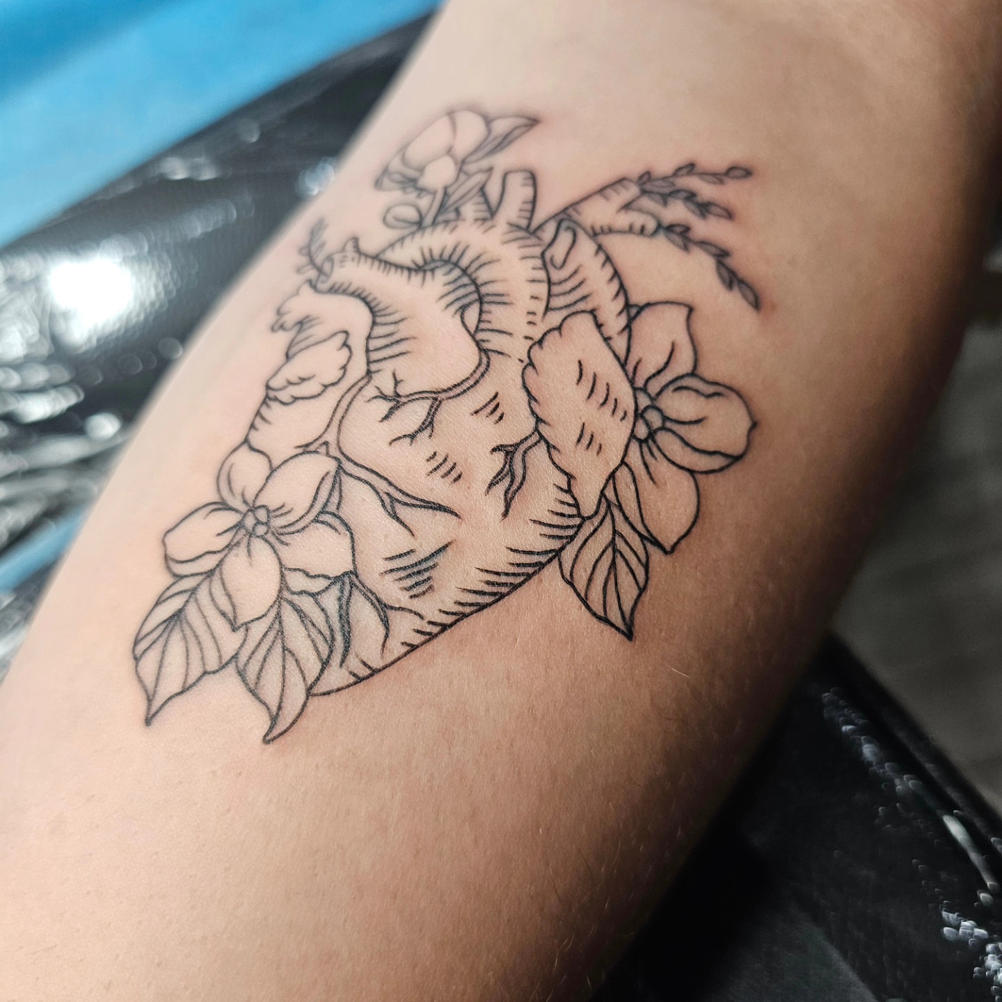 Anatomical heart with flowers black and grey tattoo on the forearm by J. Arturo Laparra