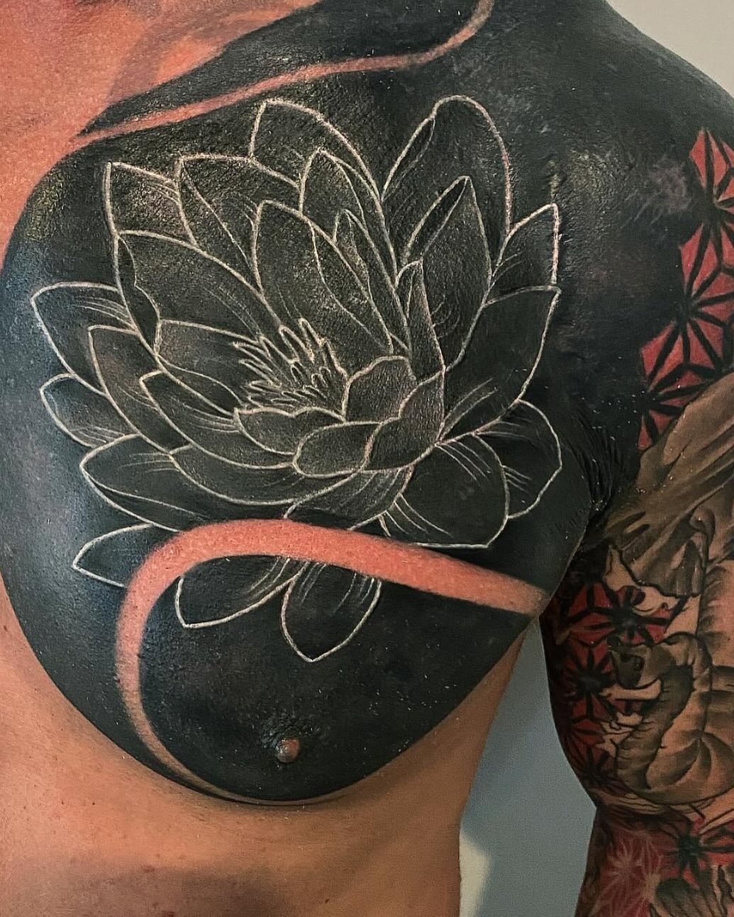 Lotus flower with black background Japanese tattoo on the shoulder by Cody Wolfe
