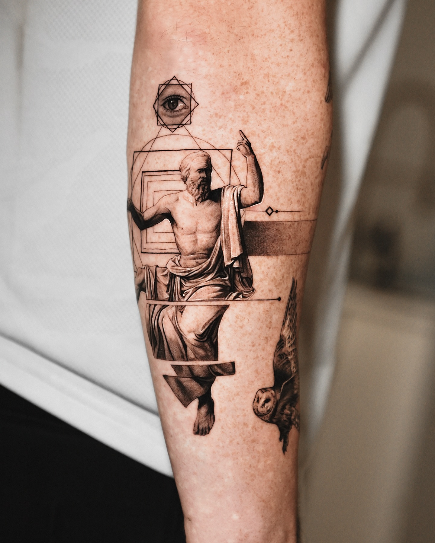 Philosopher statue realism tattoo on the forearm by Kid Needle