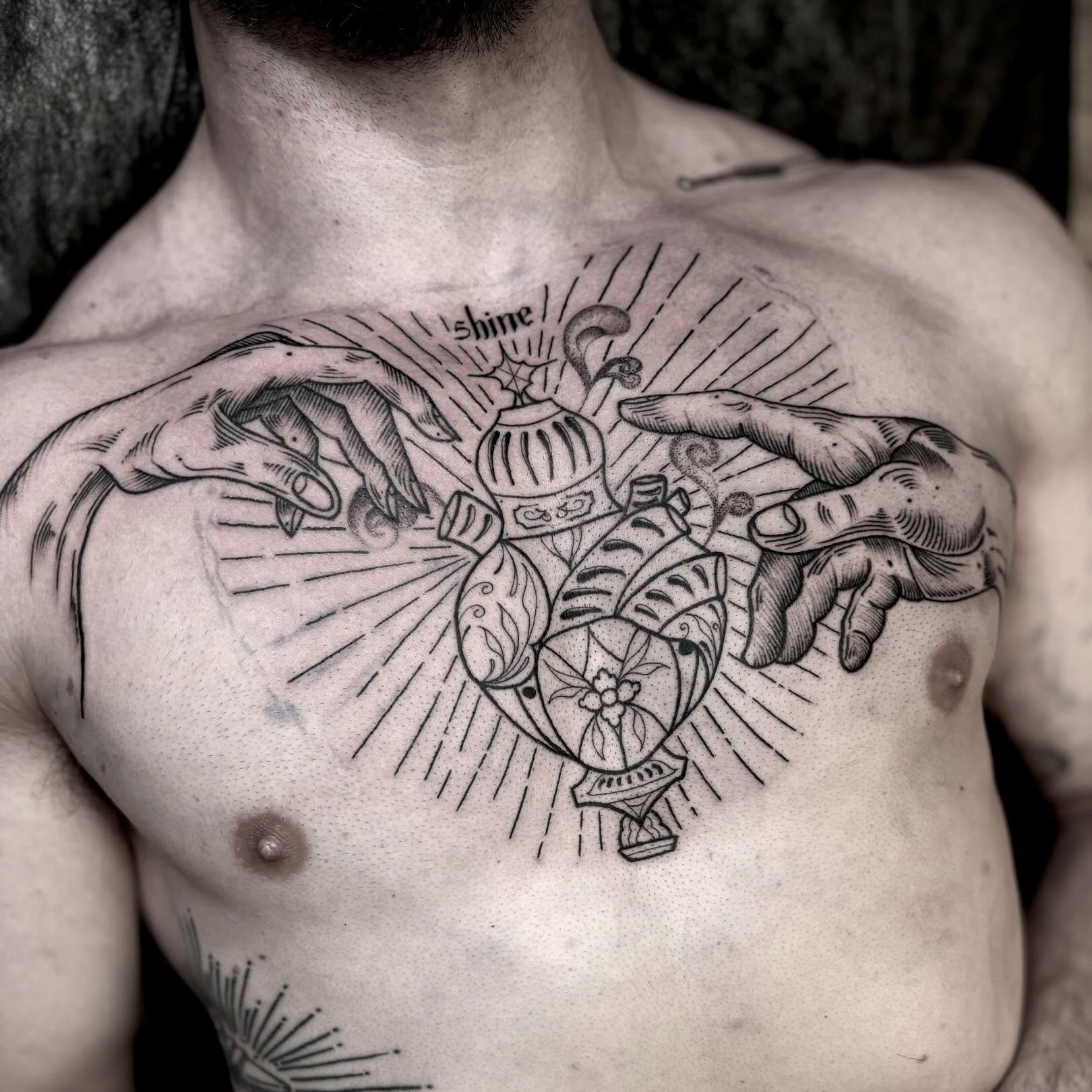 Heart with hands black and grey tattoo on the chest by t a y l o r