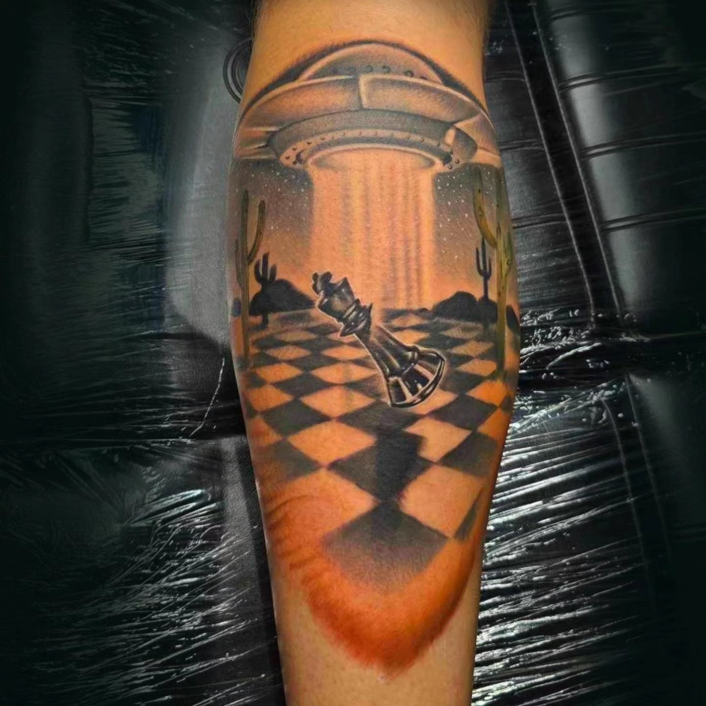 Alien abduction scene realism tattoo on the forearm by Mark Melanson
