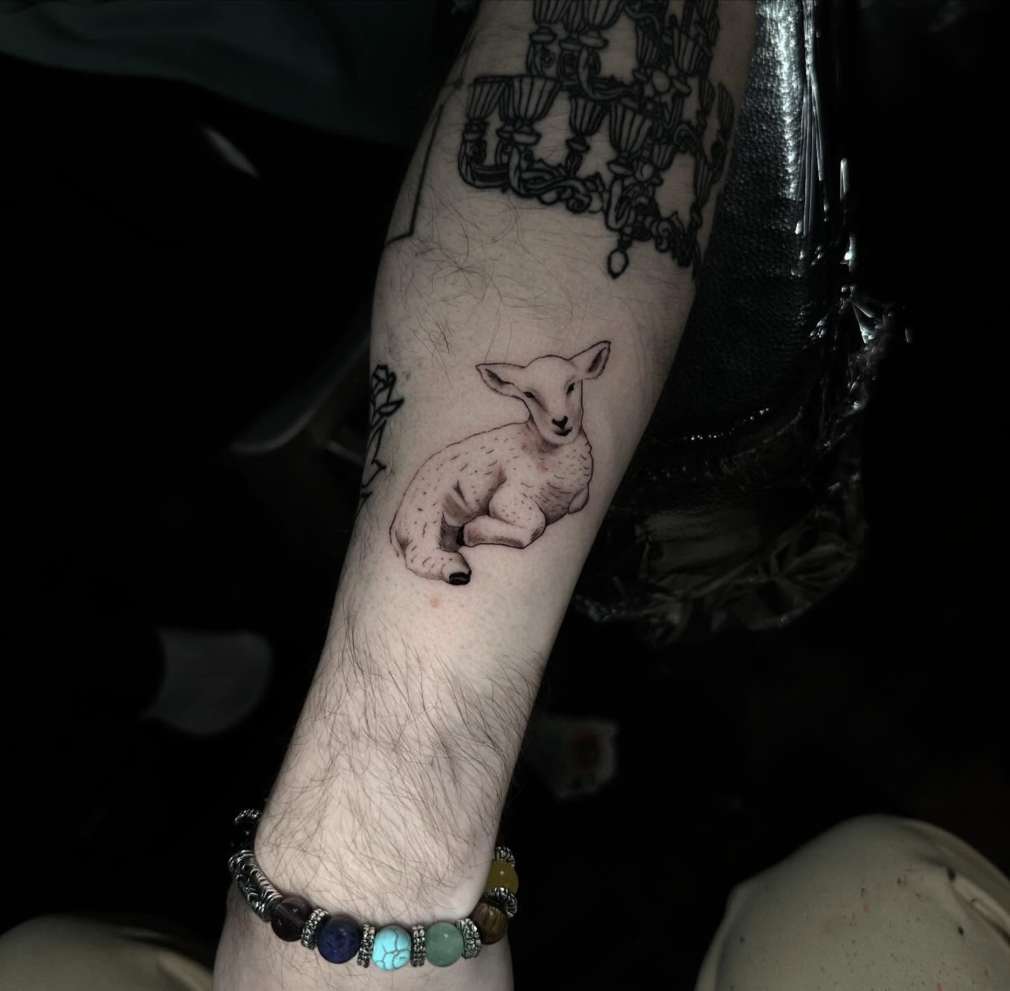 Lamb realism tattoo on the forearm by ⠀Joey Rosado