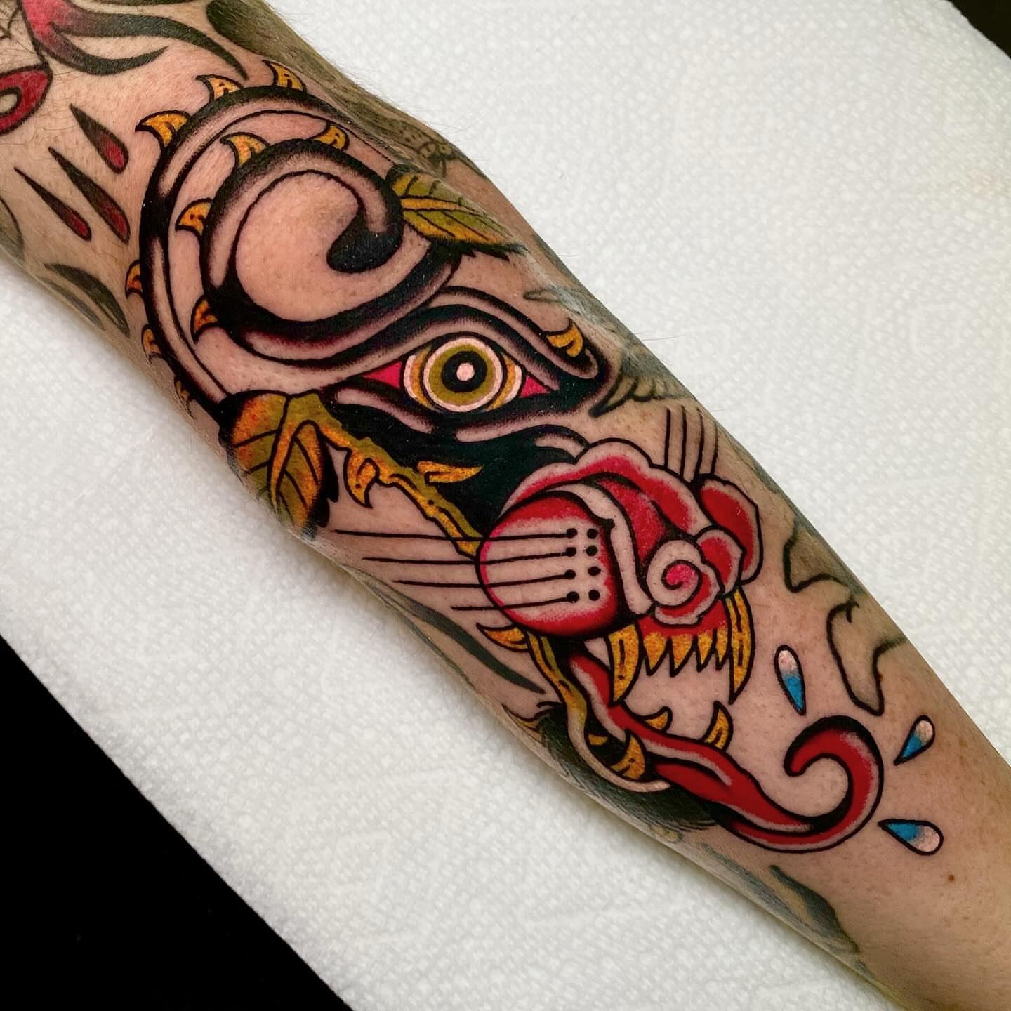 Mask and rose American traditional tattoo on the forearm by Justin R. Mitchell, Fort Worth, Texas
