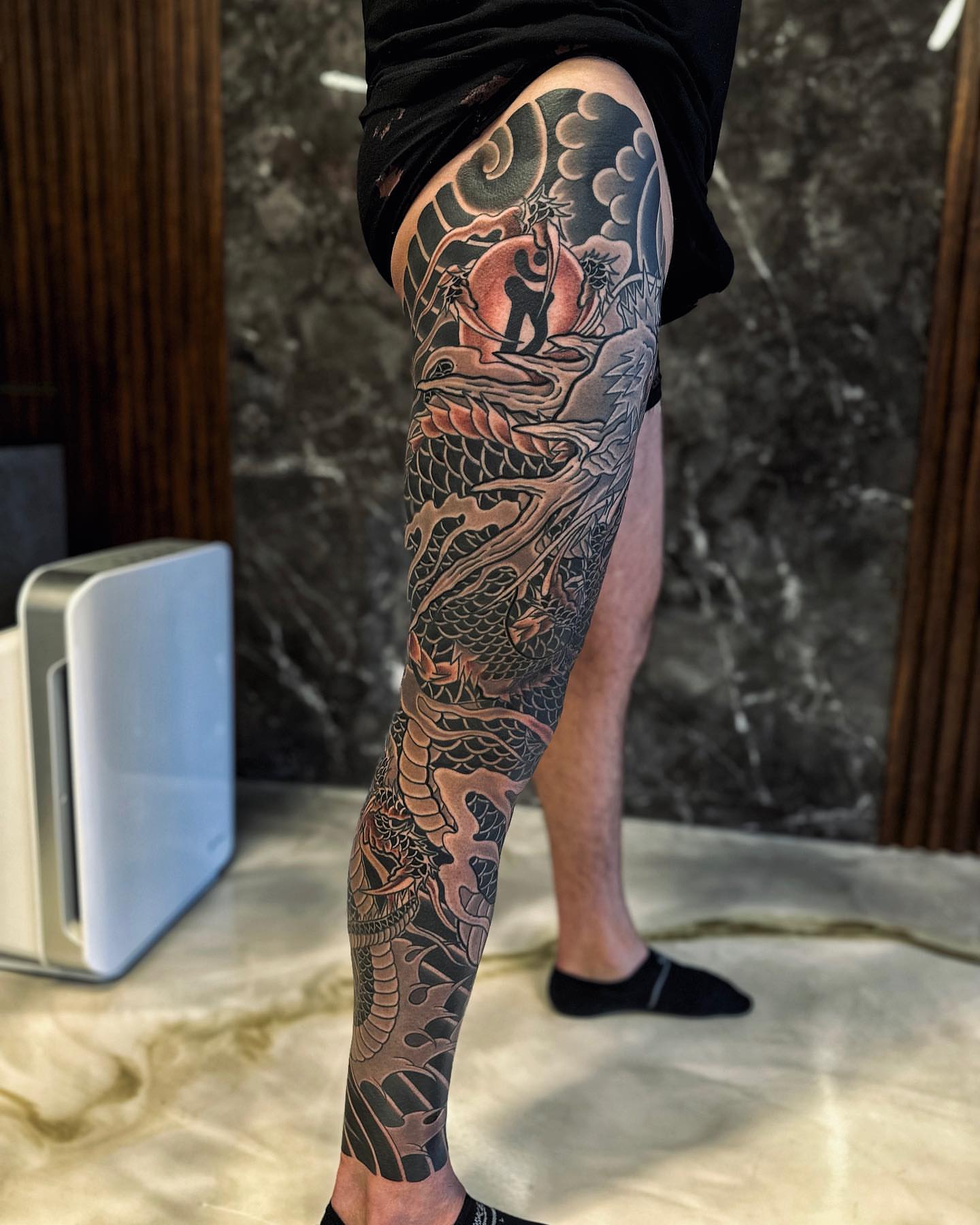 Dragon and figure japanese irezumi tattoo on the calf by Xiaojun Yin, Vancouver, British Columbia
