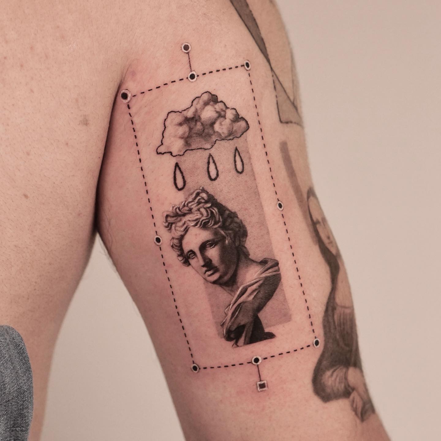 Statue bust with cloud realism tattoo on the forearm by Longtea