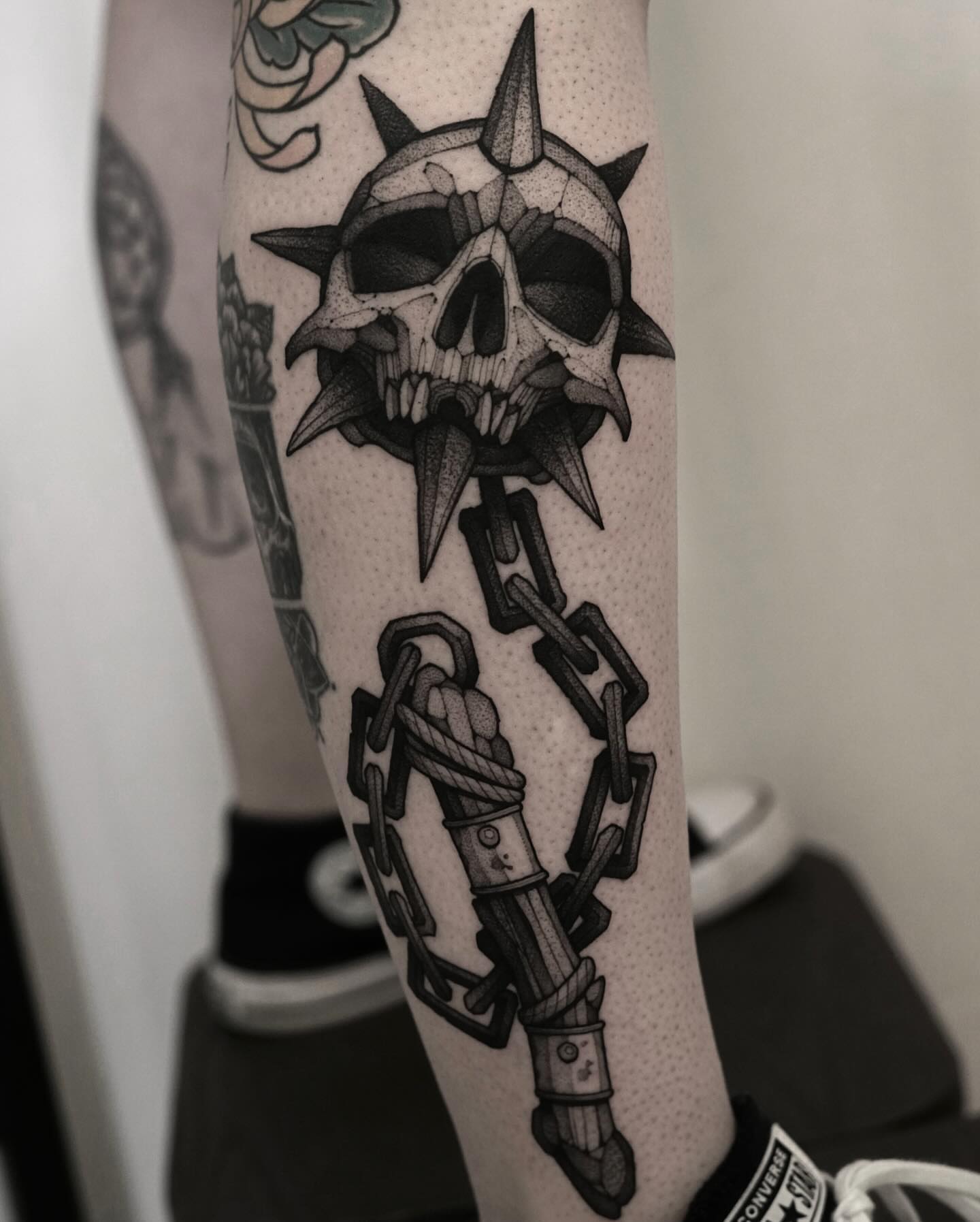 Skull and chain geometric tattoo on the forearm by Max LaCroix