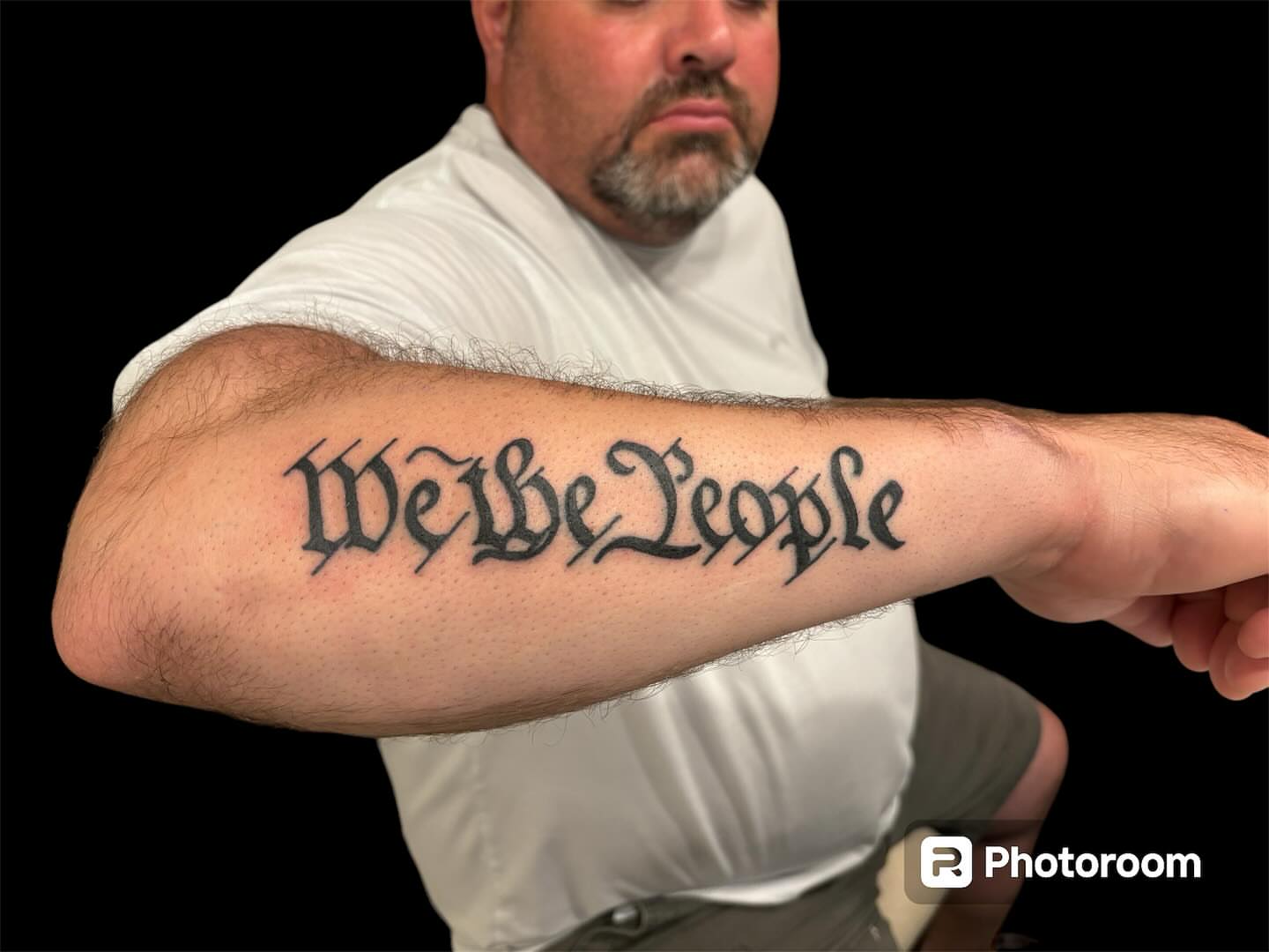 We the People lettering script tattoo on the forearm by Dale Martin