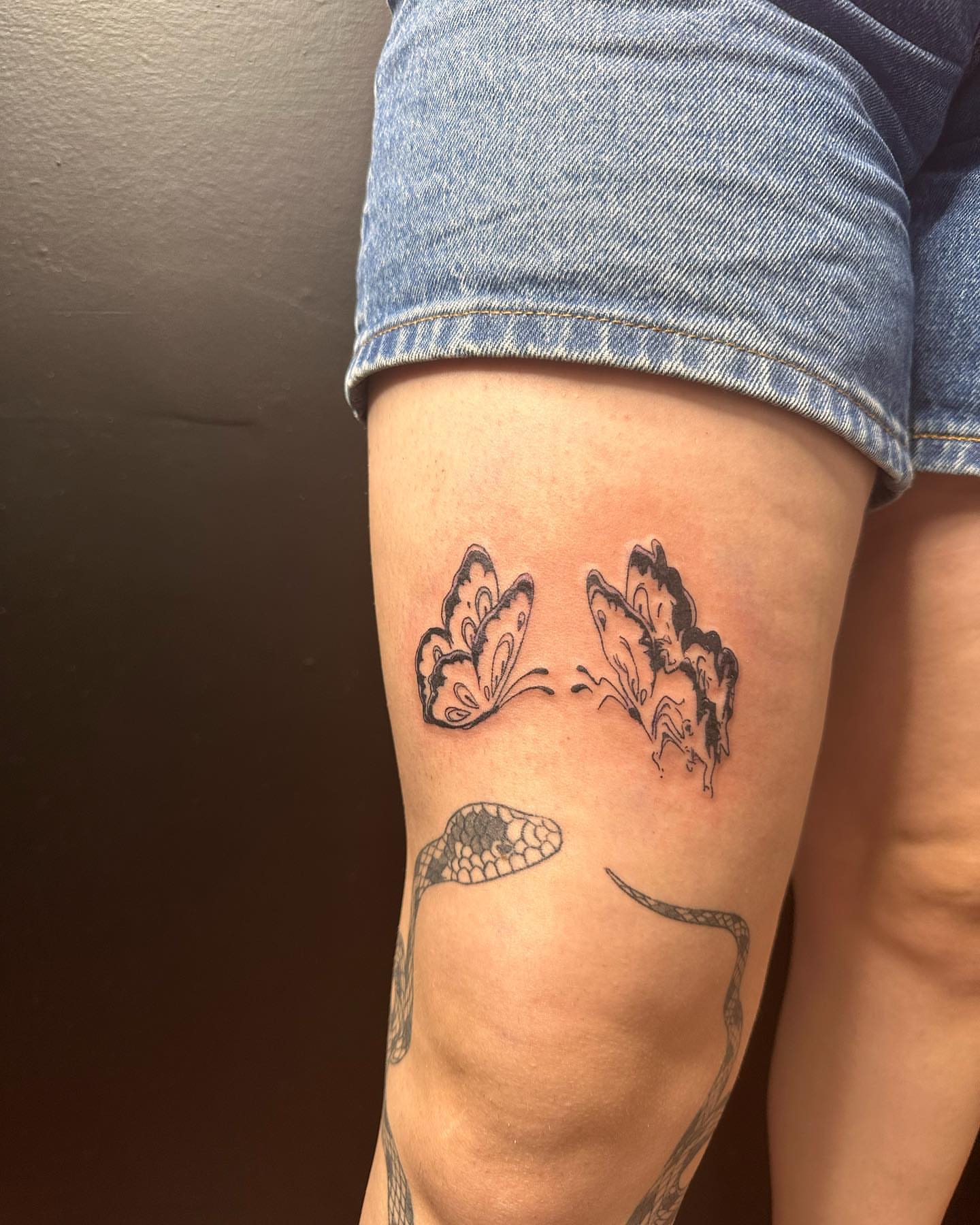 Butterfly and snake black and grey tattoo on the forearm by Kat π