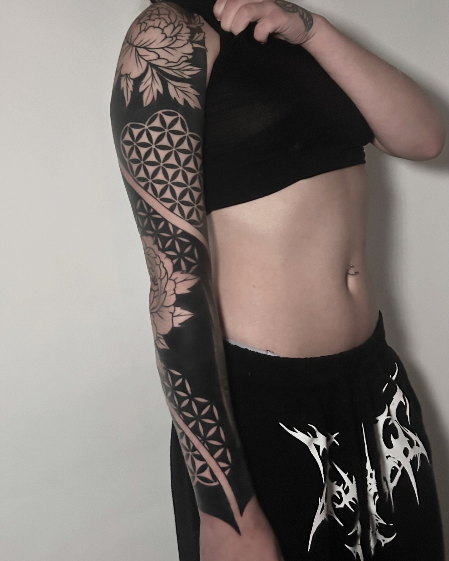 Geometric pattern geometric tattoo on the upper arm by Eric Hare