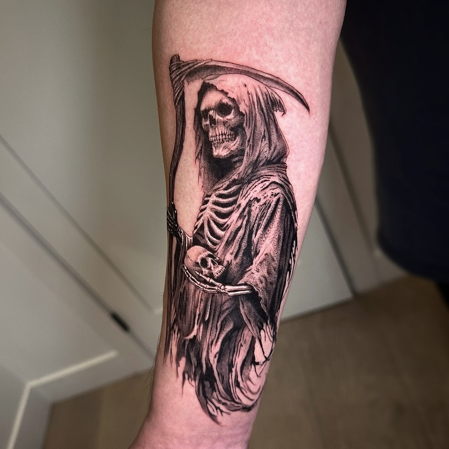 Grim reaper realism tattoo on the forearm by Oxana