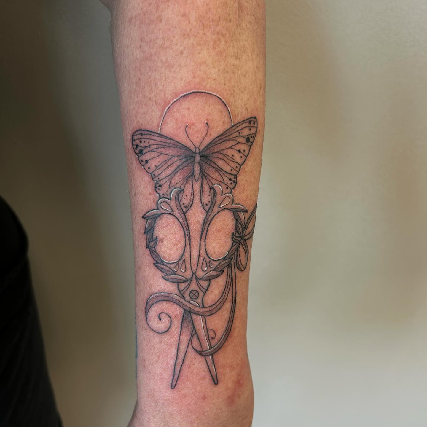Butterfly and skull geometric tattoo on the forearm by 𝕯𝖆𝖓𝖎