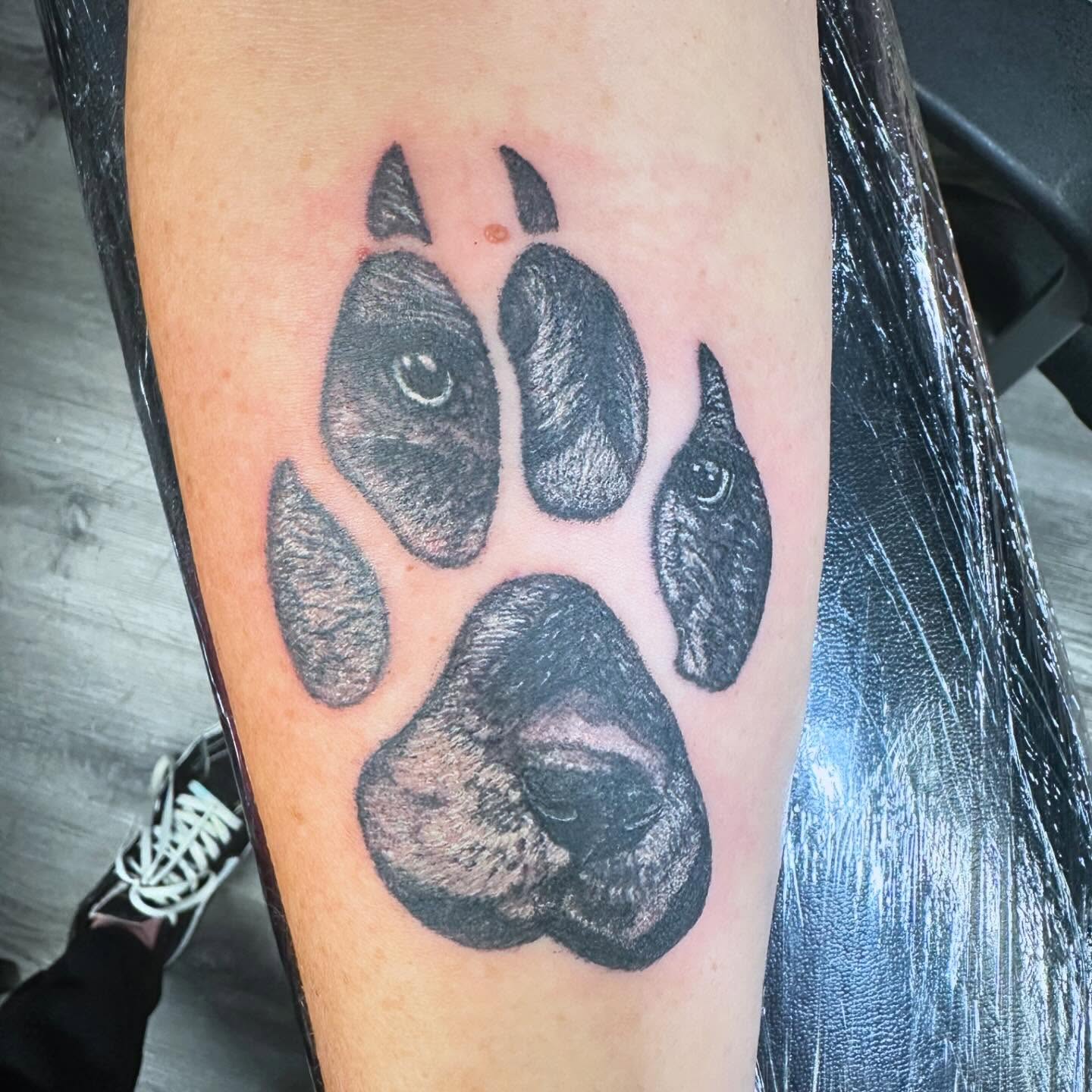 Bear paw print black and grey tattoo on the forearm by Madeline, Akron, Ohio