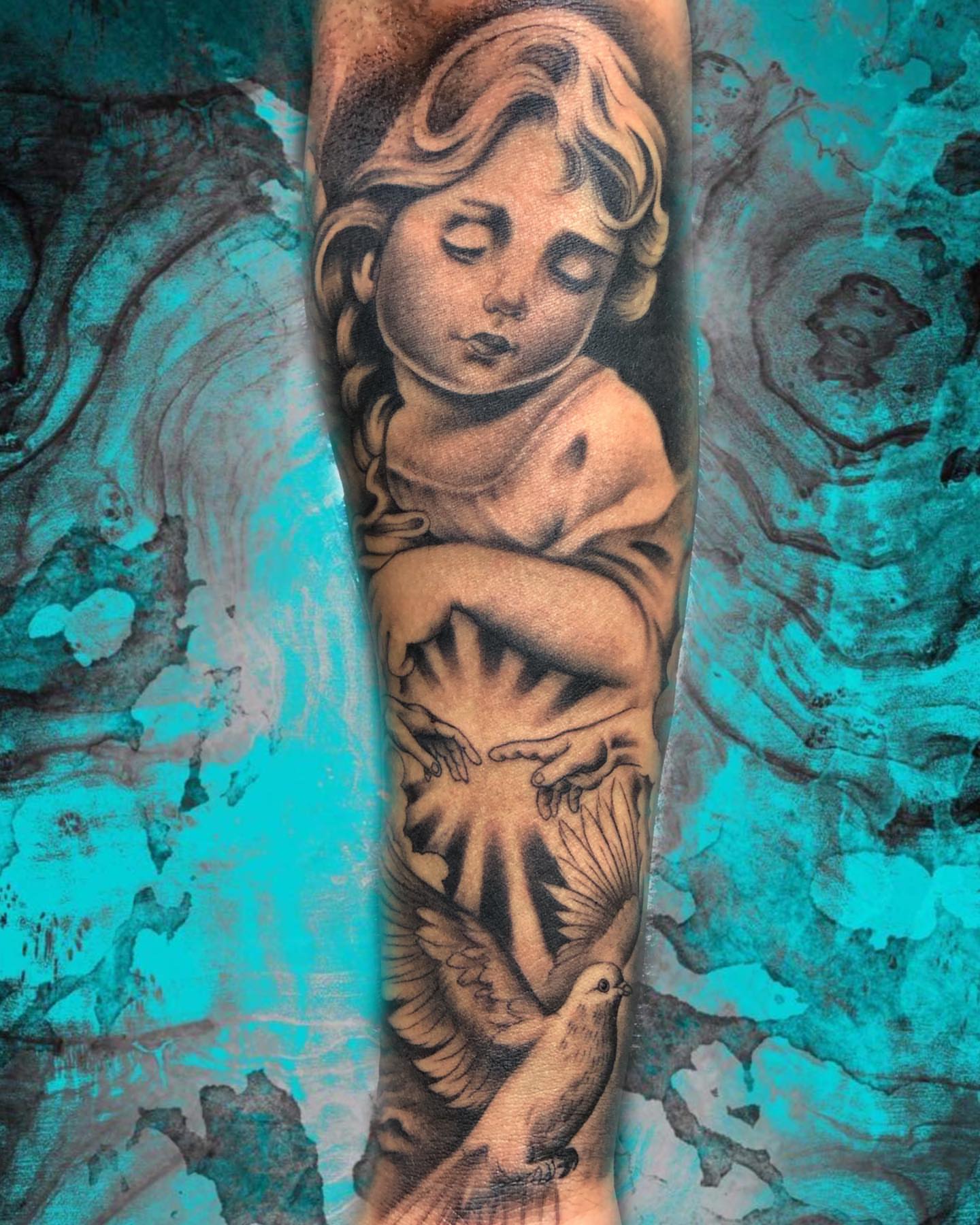 Cherub with dove American traditional tattoo on the forearm by Luis Chauta