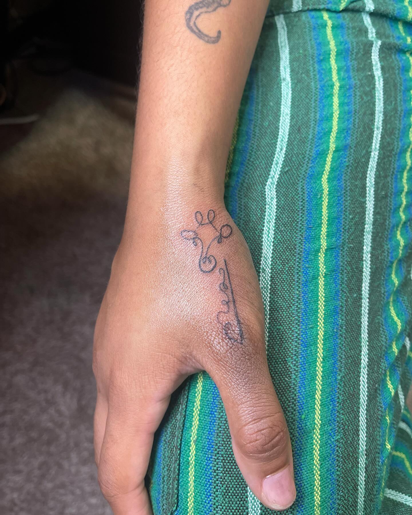 Floral vine fine line tattoo on the forearm by Danny Garcia