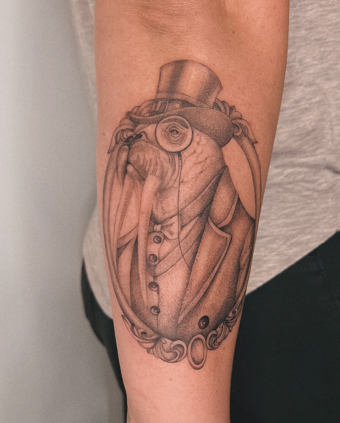 Octopus in top hat realism tattoo on the forearm by Blackwork & microrealism tattoos