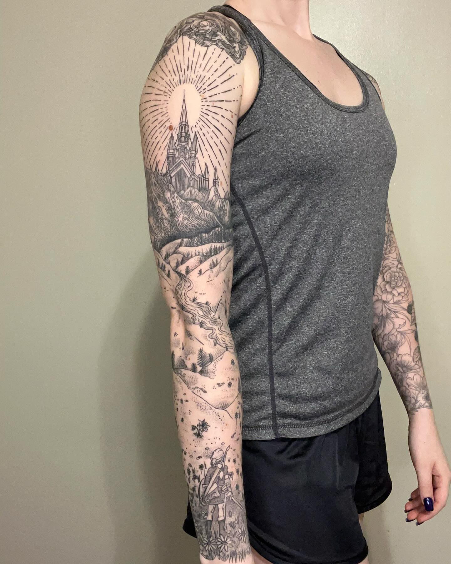 Church and landscape black and grey tattoo on the upper arm by Marissa Losier