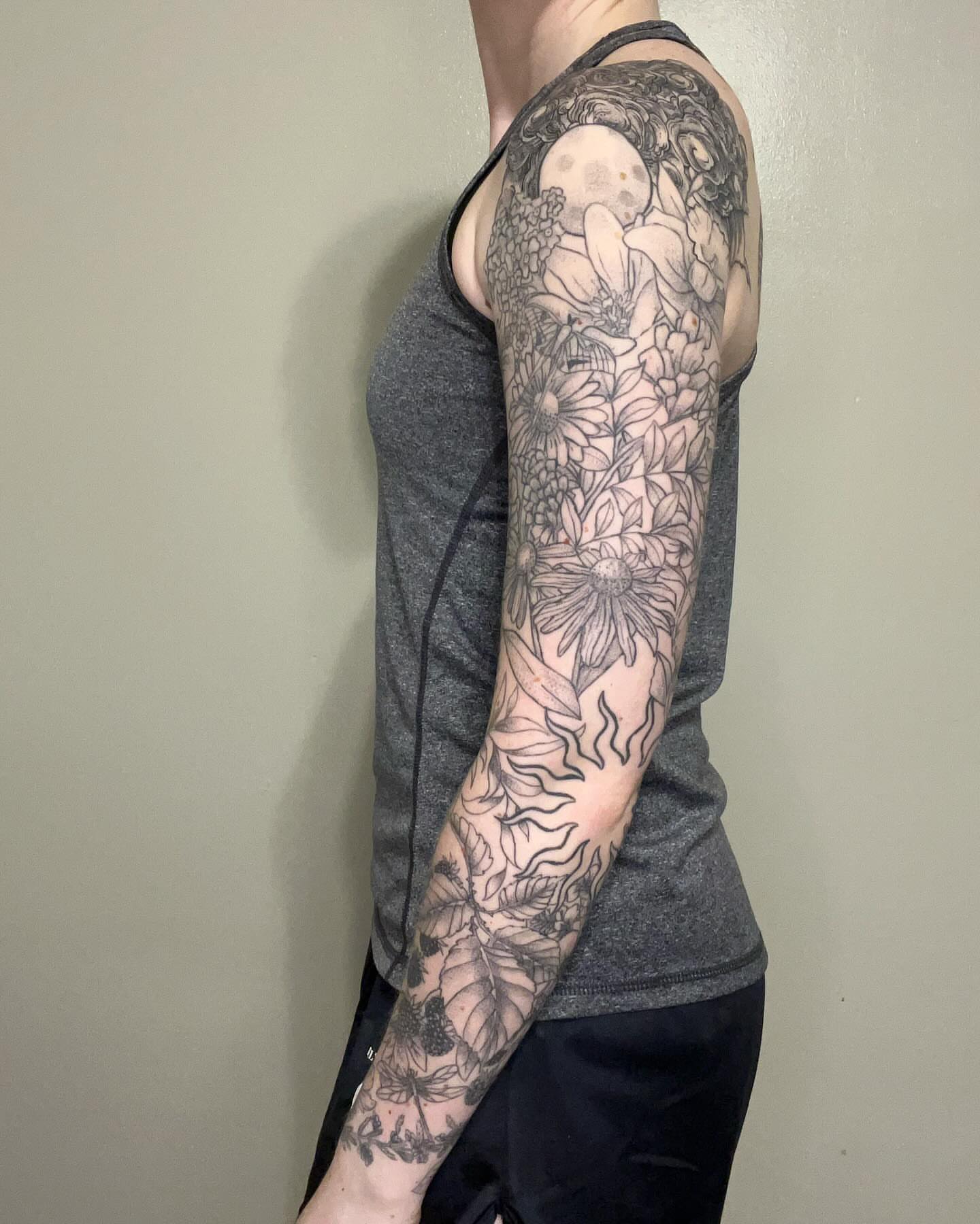 Floral bouquet black and grey tattoo on the upper arm by Marissa Losier