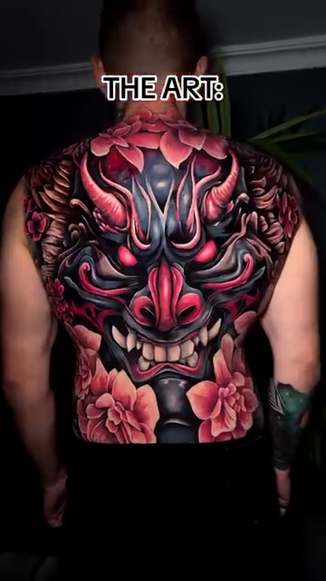 Oni mask and flowers Japanese tattoo on the upper arm by Kaly, Manhattan, NYC