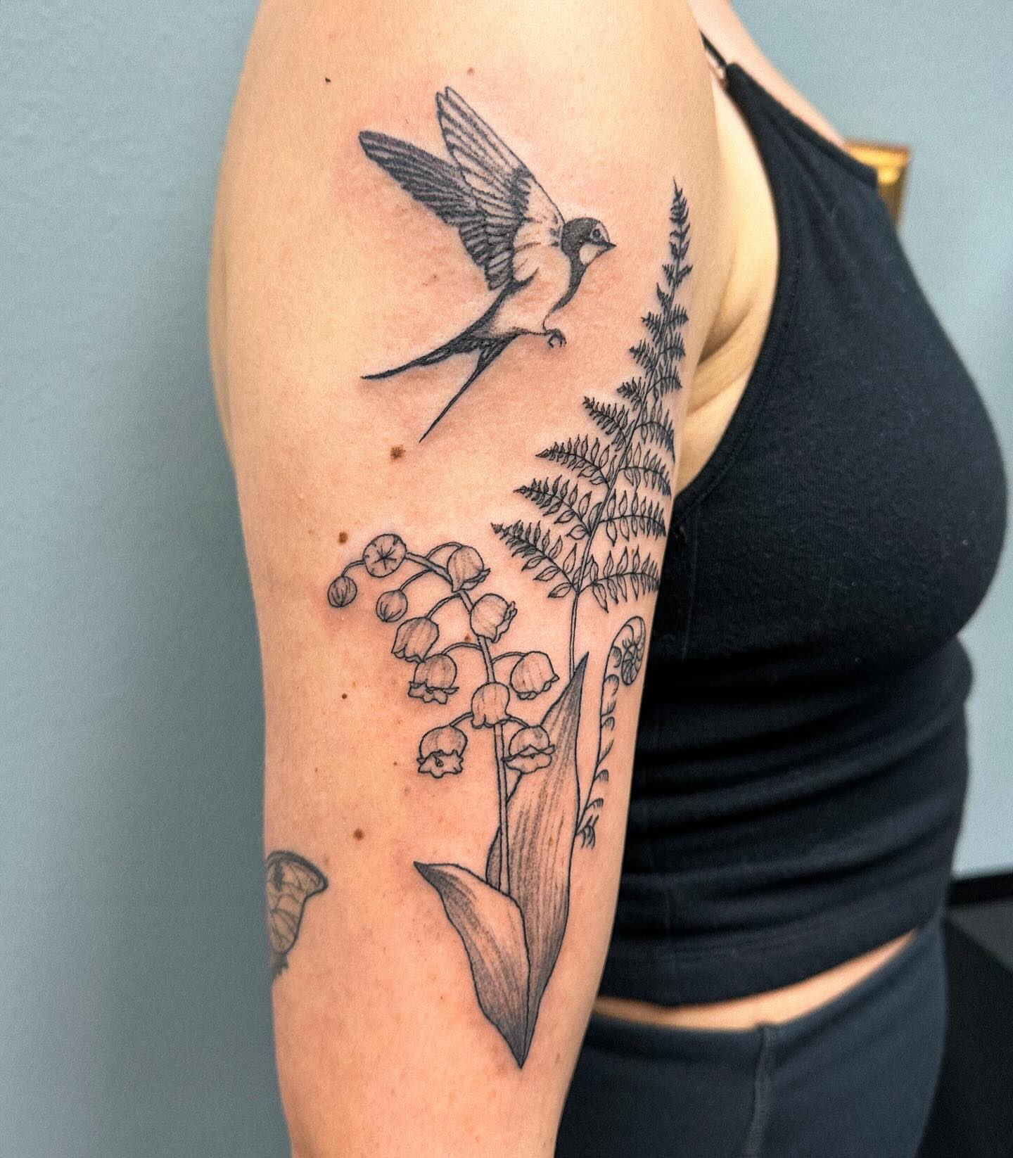 Bird and lily of the valley black and grey tattoo on the forearm by Portland Tattoo Artist
