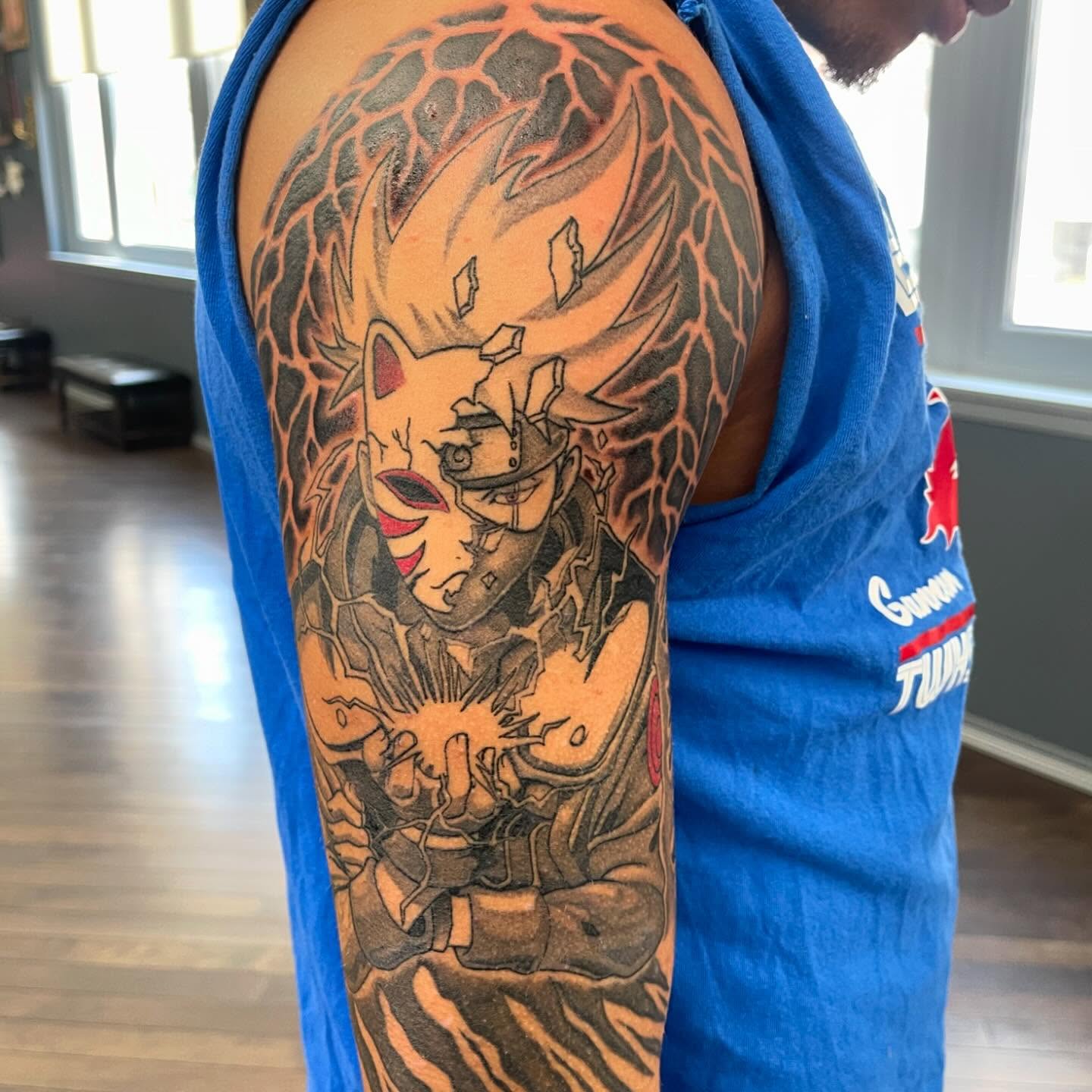 Anime character anime tattoo on the upper arm by Ohio Realism Tattoo Artist