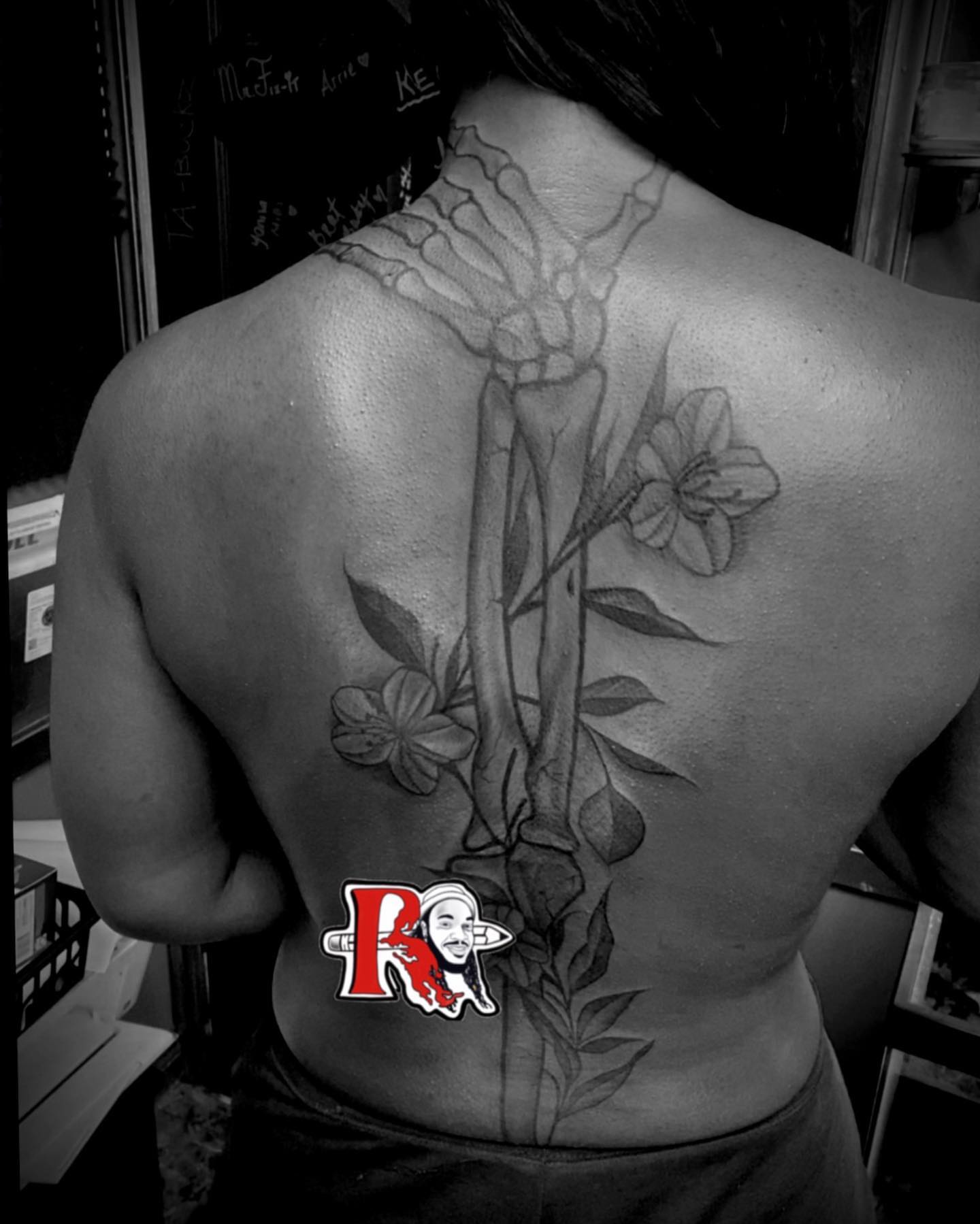 Bone and flower realism tattoo on the back by Chicago Tattoo Artist
